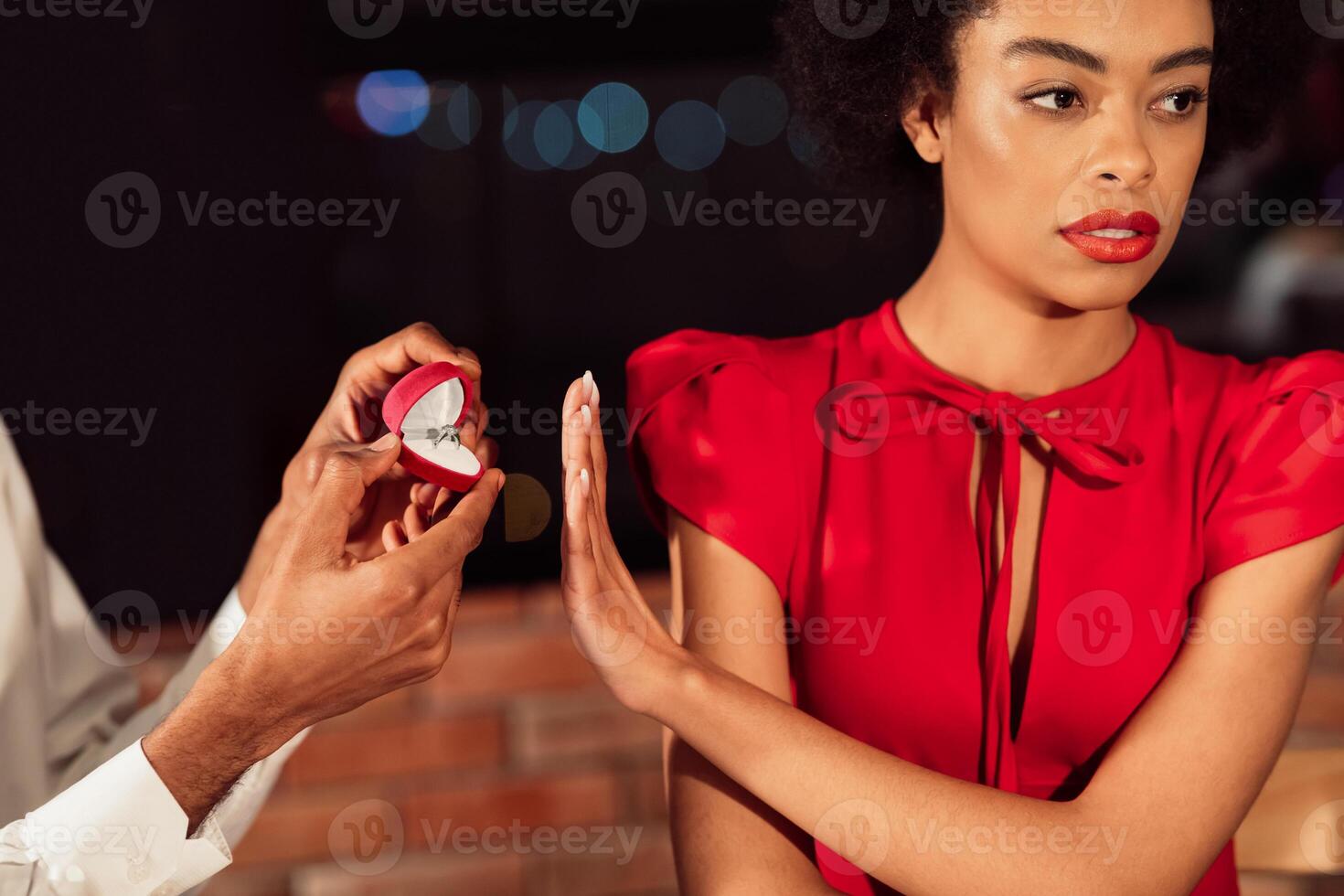 Refusing Marriage Proposal. Afro Girl Gesturing Stop To Offered Engagement Ring Rejecting Her Boyfriend In Restaurant. Cropped photo