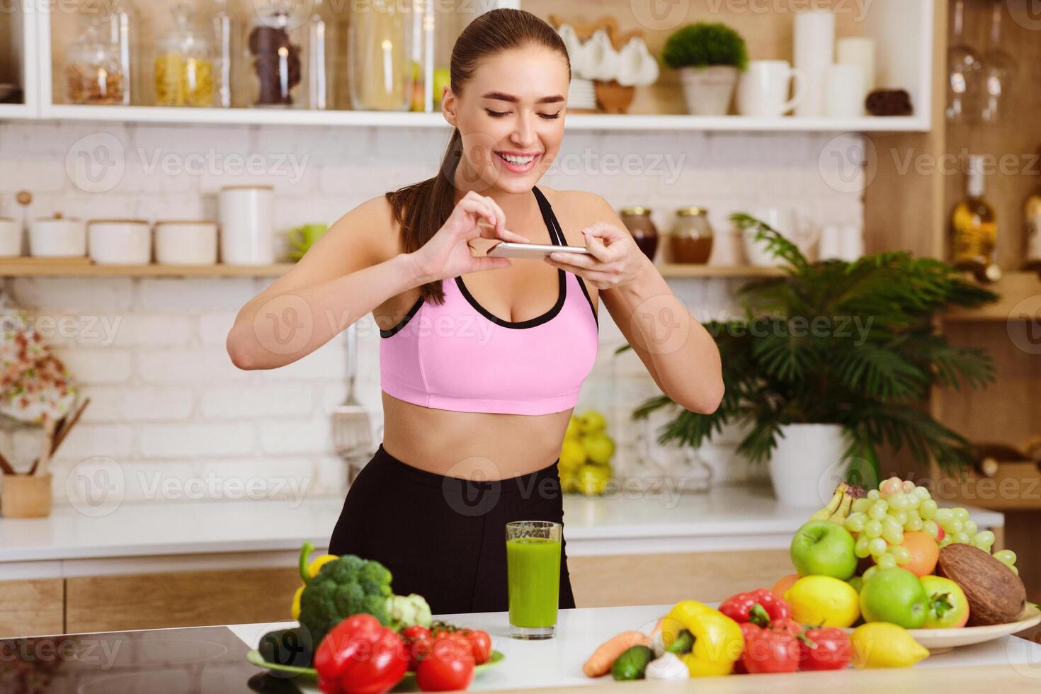 Sport Blogger Taking Photo Of Detox Juice On Smartphone For Her Blog