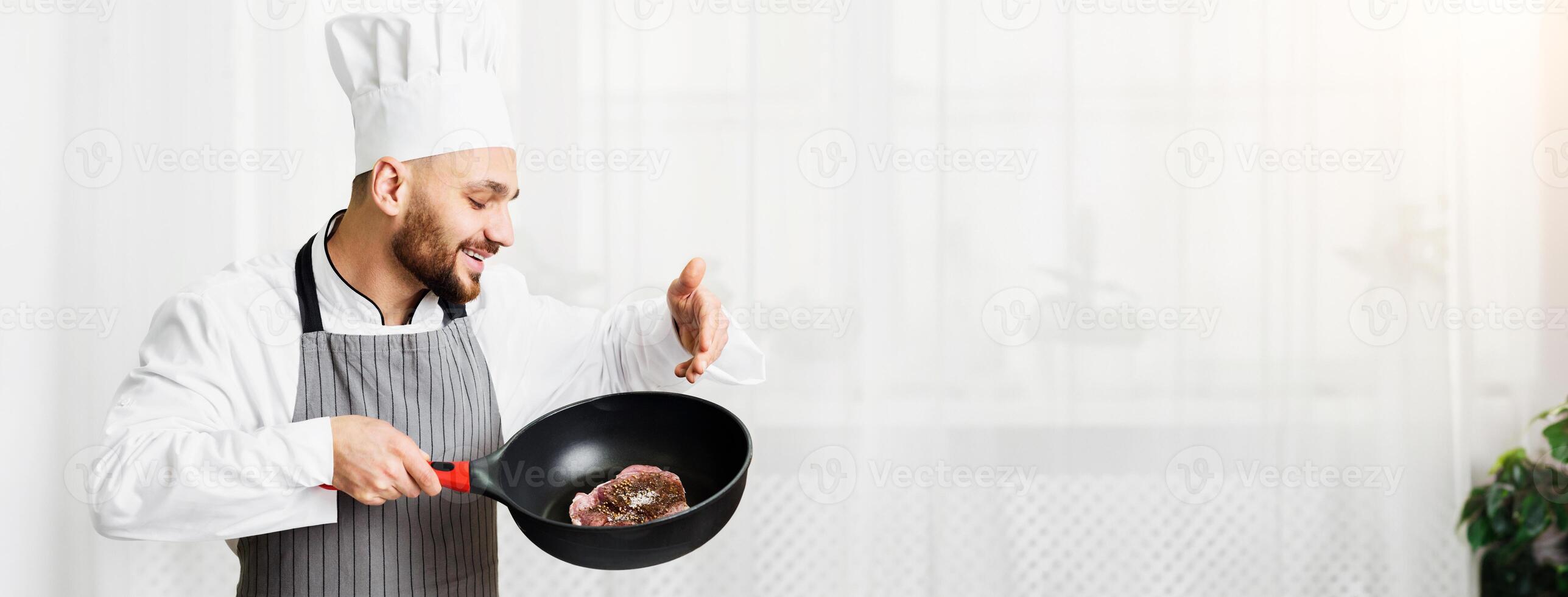 Cooking Meat. Chef Man Holding Pan With Fresh Roast Beef Steak Standing In Restaurant Kitchen Indoor. photo