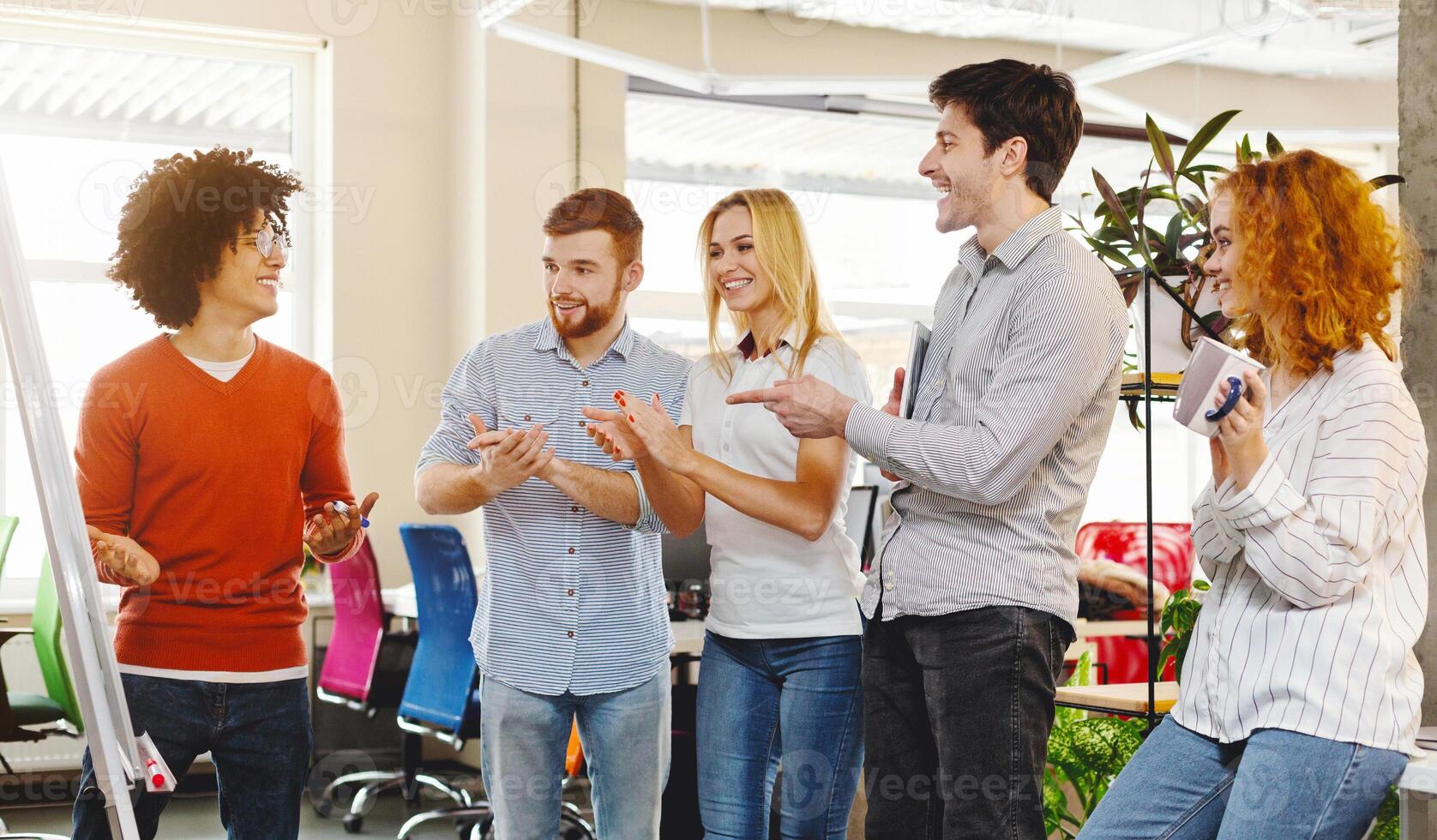 Business team appreciating colleague for explaining presentation, applauding in co-working space photo