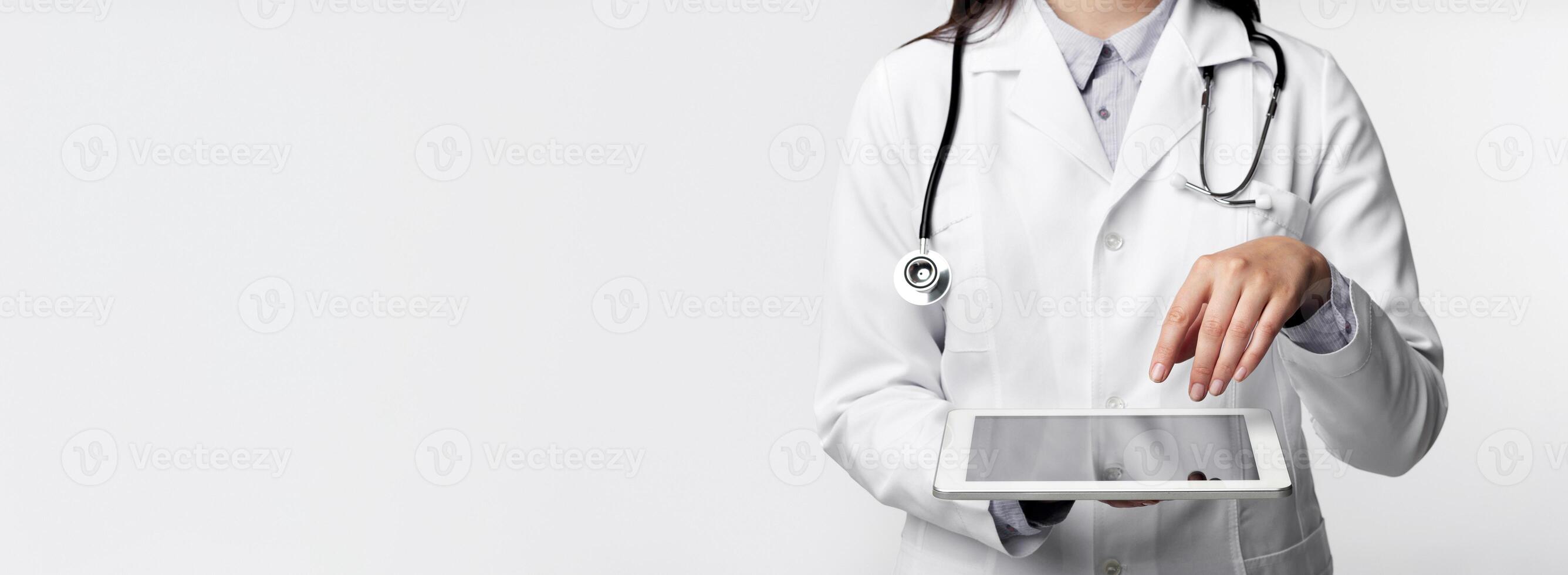 Innovative Medical Technologies. Unrecognizable Doctor Using Tablet Computer Over White Background. Studio Shot, Cropped photo