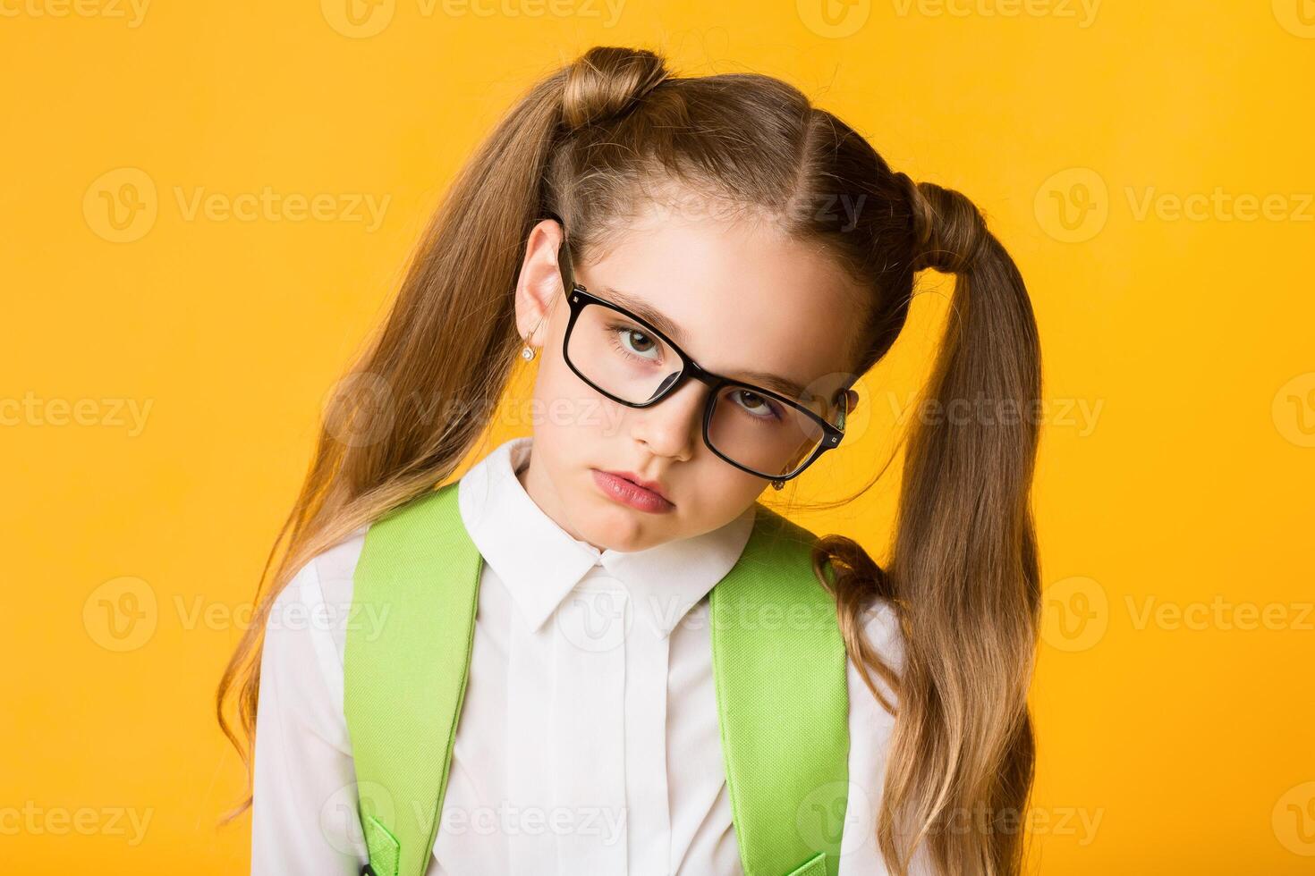Tired Of School. Overworked Schoolgirl Looking At Camera Posing Over Yellow Studio Background. photo