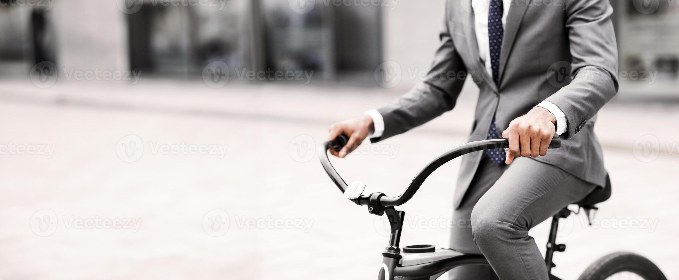An executive is biking to work in an urban setting. The mood is energetic and productive, capturing the essence of a modern professional lifestyle, cropped photo