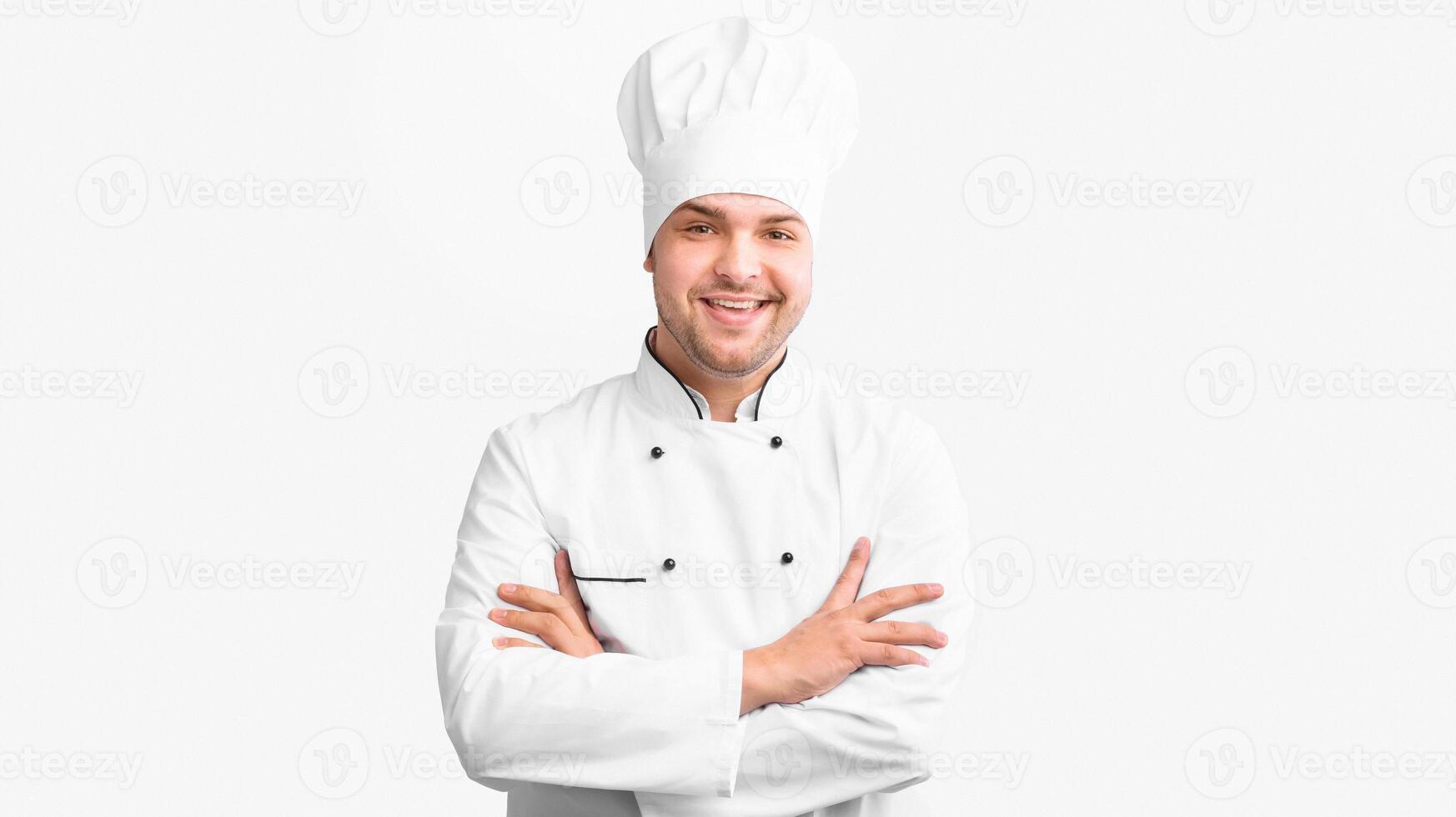 Smiling Chef Man Standing Crossing Hands Looking At Camera Over White Background In Studio. Panorama photo
