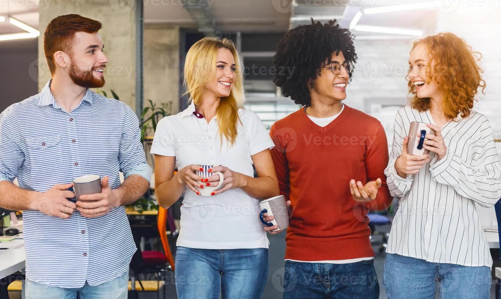 A gathering of individuals standing closely aligned in a row, facing forward, engaged in conversation or awaiting further instructions while drinking coffee photo