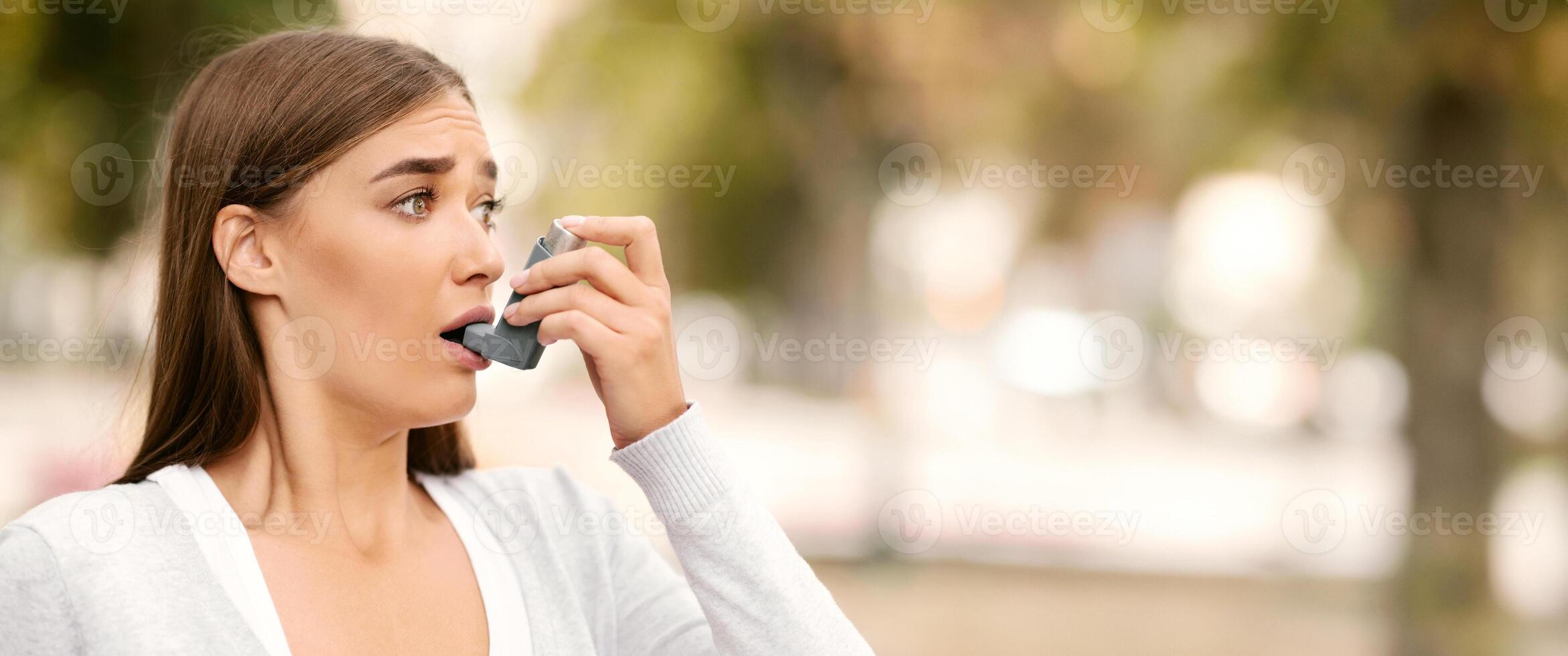 Asthma Disease. Woman Having Asthmatic Attack Using Inhaler Preventing Respiratory Depression Standing Outdoor. photo