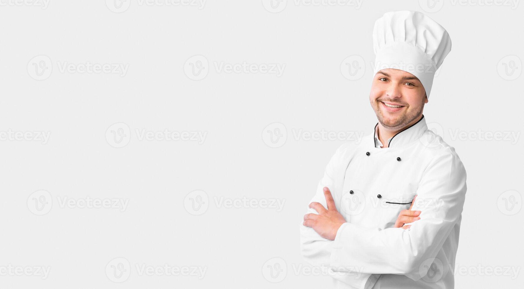 Chef's Career. Cook Guy Standing Crossing Hands Posing Over White Background In Studio. Panorama With Free Space photo