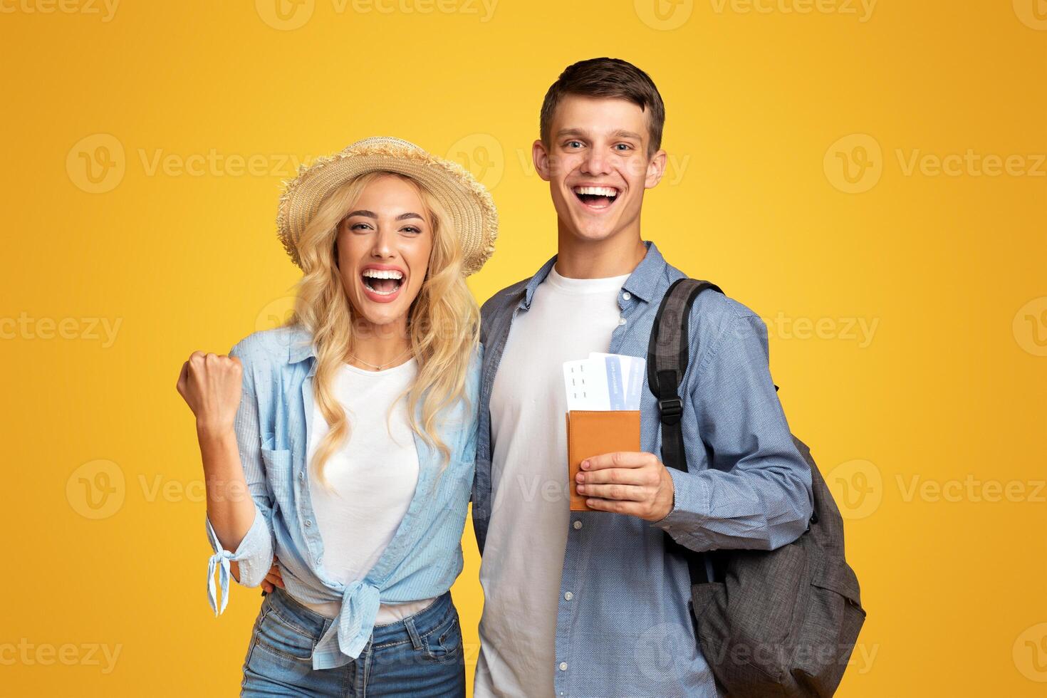 Hooray, we're going to vacation. Portrait of happy young couple with passports and tickets, excited about future trip photo