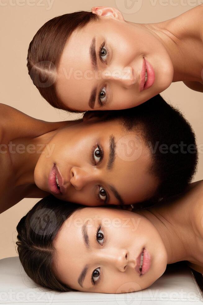 Multiracial Beauty. Portrait Of Multiethnic Asian, African American And Caucasian Women Looking At Camera Posing Over Gray Studio Background. Vertical photo