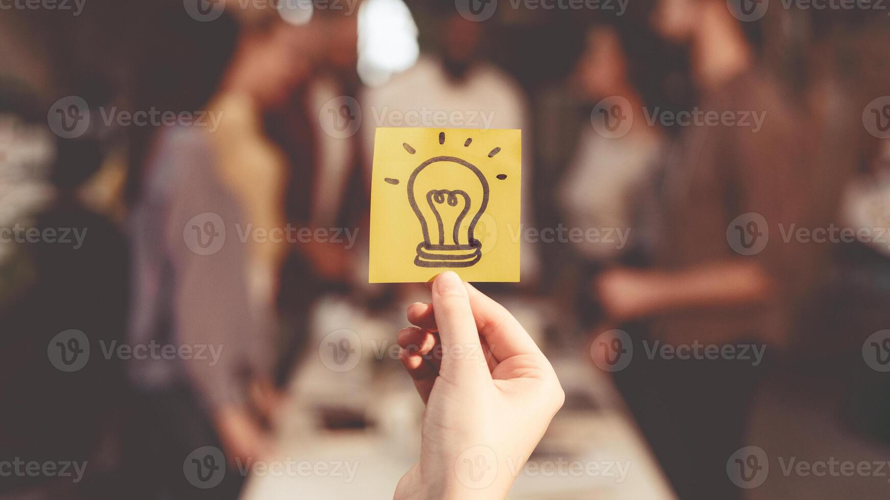 New idea concept. Business team discussing startup project, picture of light bulb on foreground photo