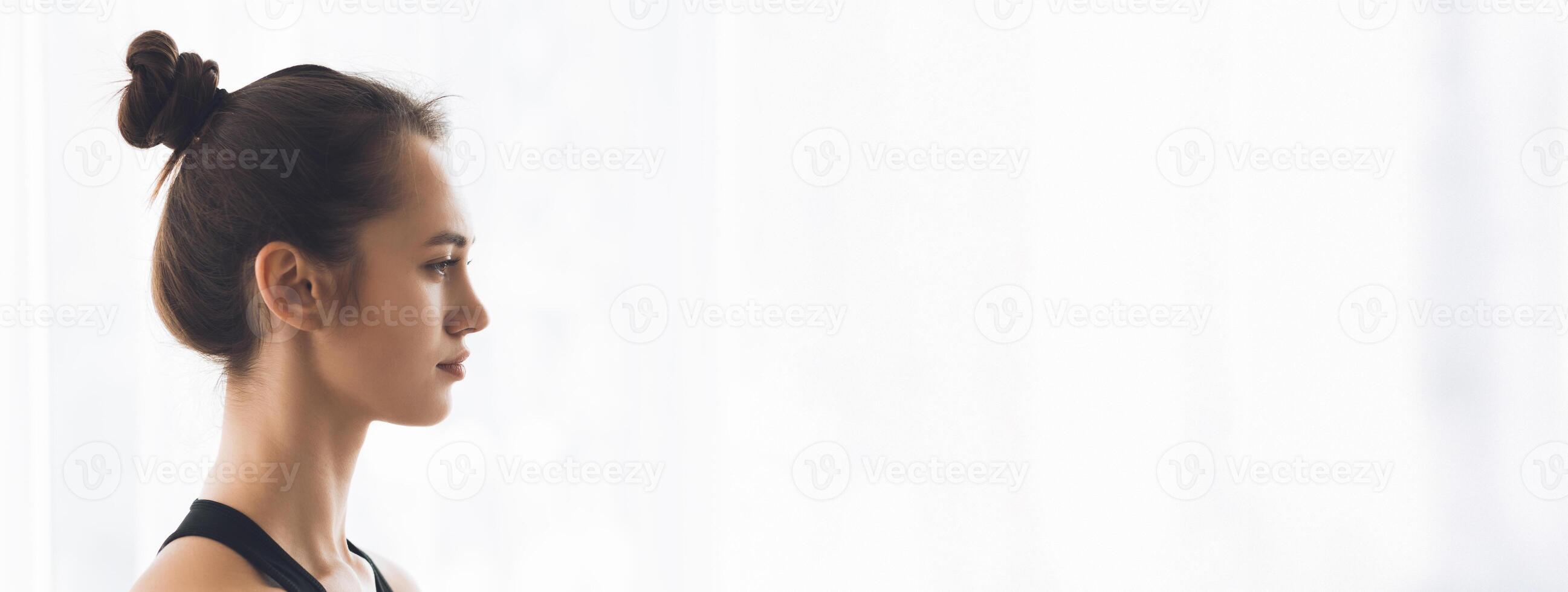 A woman sits peacefully, focusing on mindfulness and self-reflection in a bright, tranquil environment, copy space photo