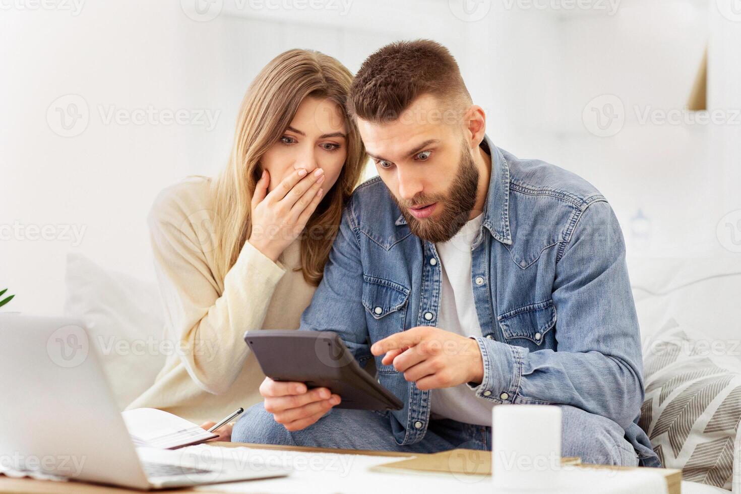 A man and woman are engaged in viewing information on a tablet device together. photo