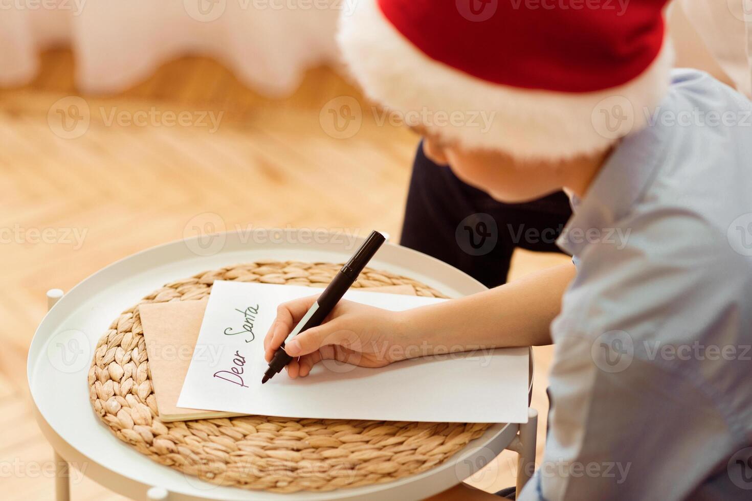Xmas Gifts Wishlist. Boy Writing Letter To Santa Claus Sitting On Sofa At Home. Selective Focus photo