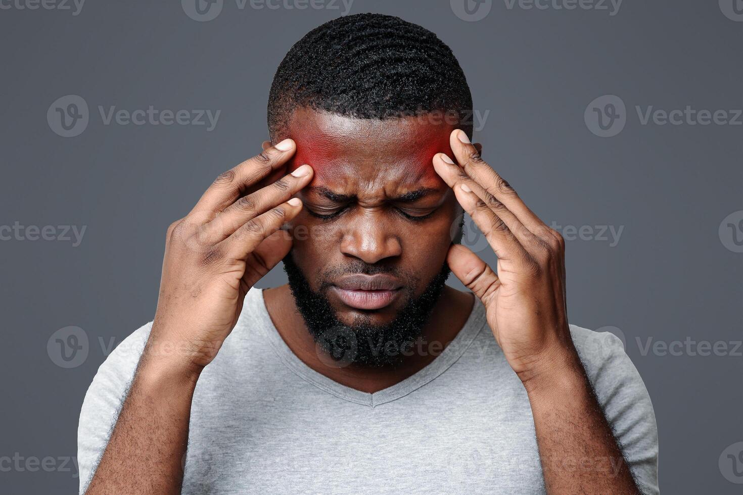 Young afro man having headache, touching his temples, migraine concept photo
