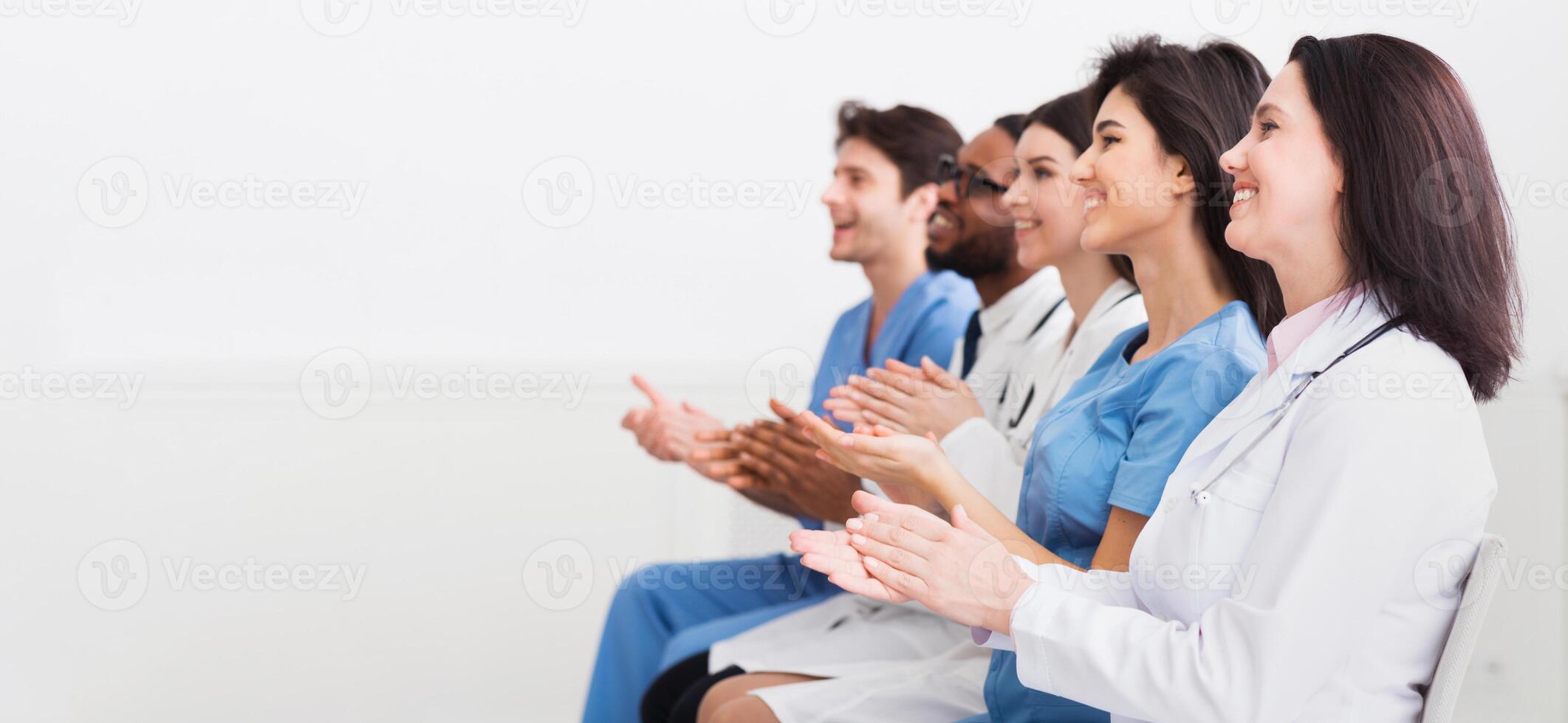General Practitioners Applauding To Successful Lecturer, Sitting In Conference Room photo