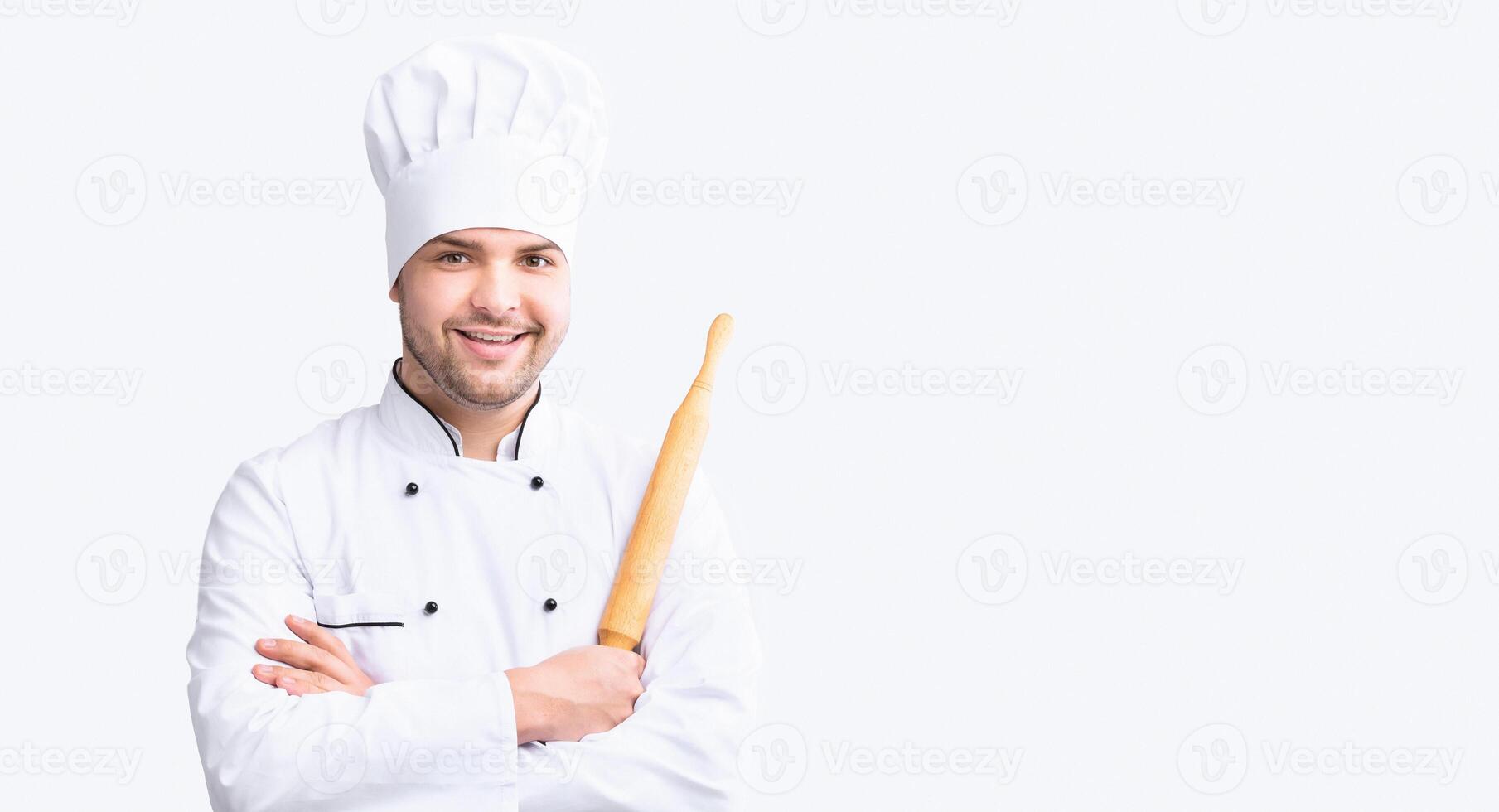Cheerful Baker Man Holding Dough Rolling Pin Smiling To Camera Standing On White Studio Background. Pastry Recipes. Panorama. photo