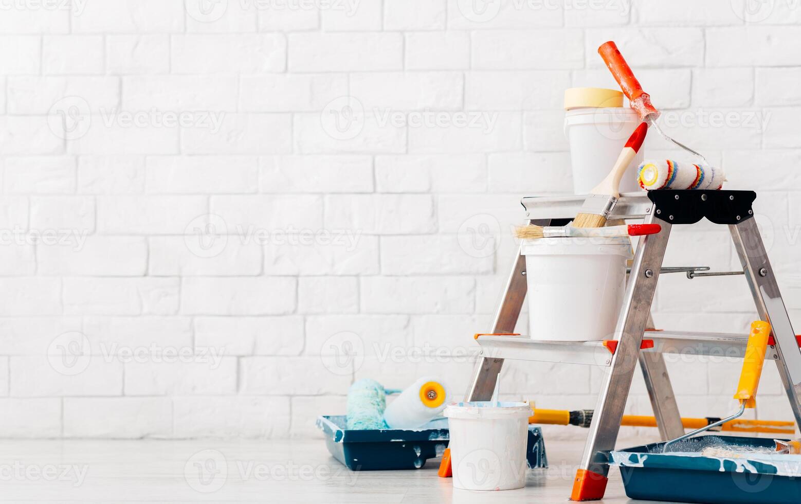 Repair, instruments and materials for painting walls, white bricks wall background, copy space photo