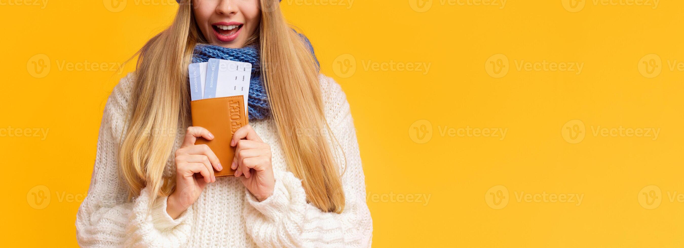 Discount for winter holidays. Cropped image of blonde girl holding passport with tickets over pink background, panorama with copy space photo