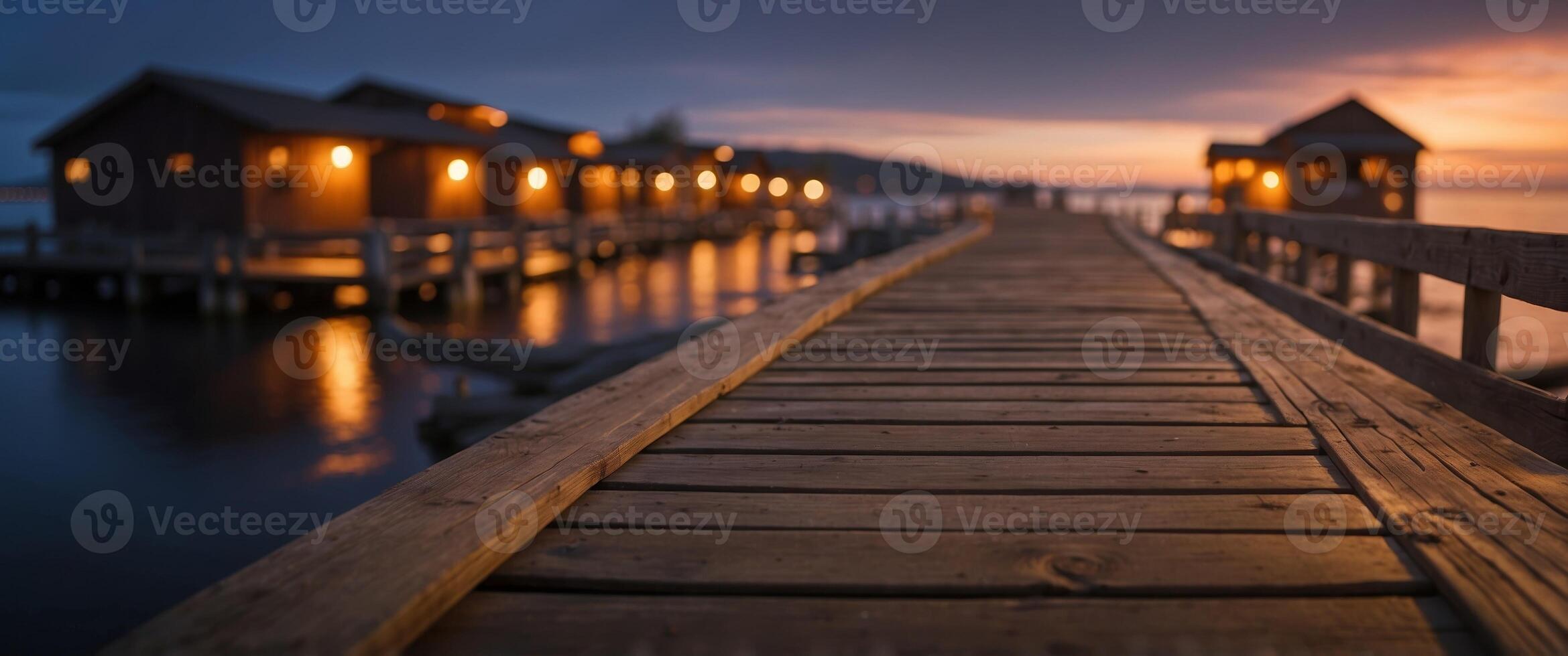 A wooden dock with houses on it at sunset photo