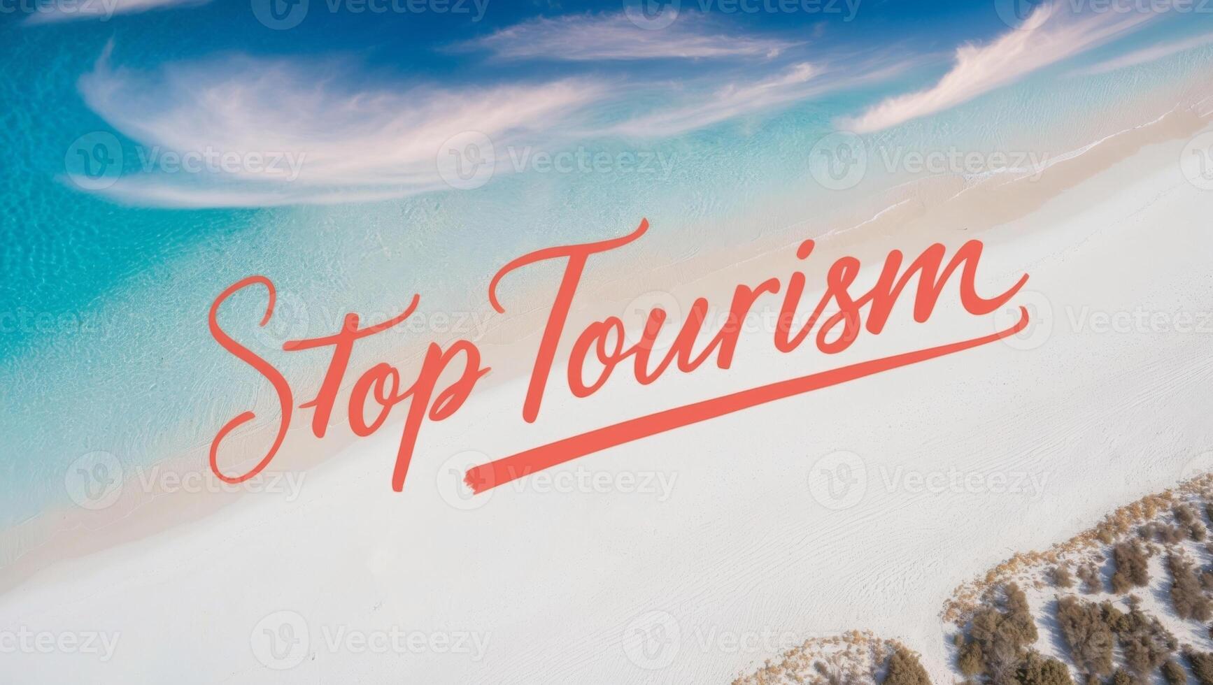An aerial view captures a beautiful beach featuring the phrase stop tourism written in the sand. photo