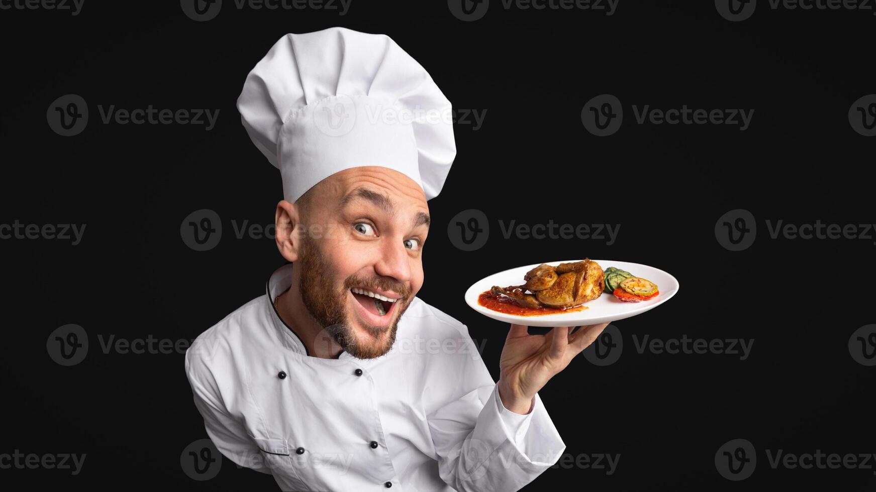 Funny Chef Cook Man Showing Chicken Dish On Plate Posing On Black Background. Panorama, Studio Shot photo