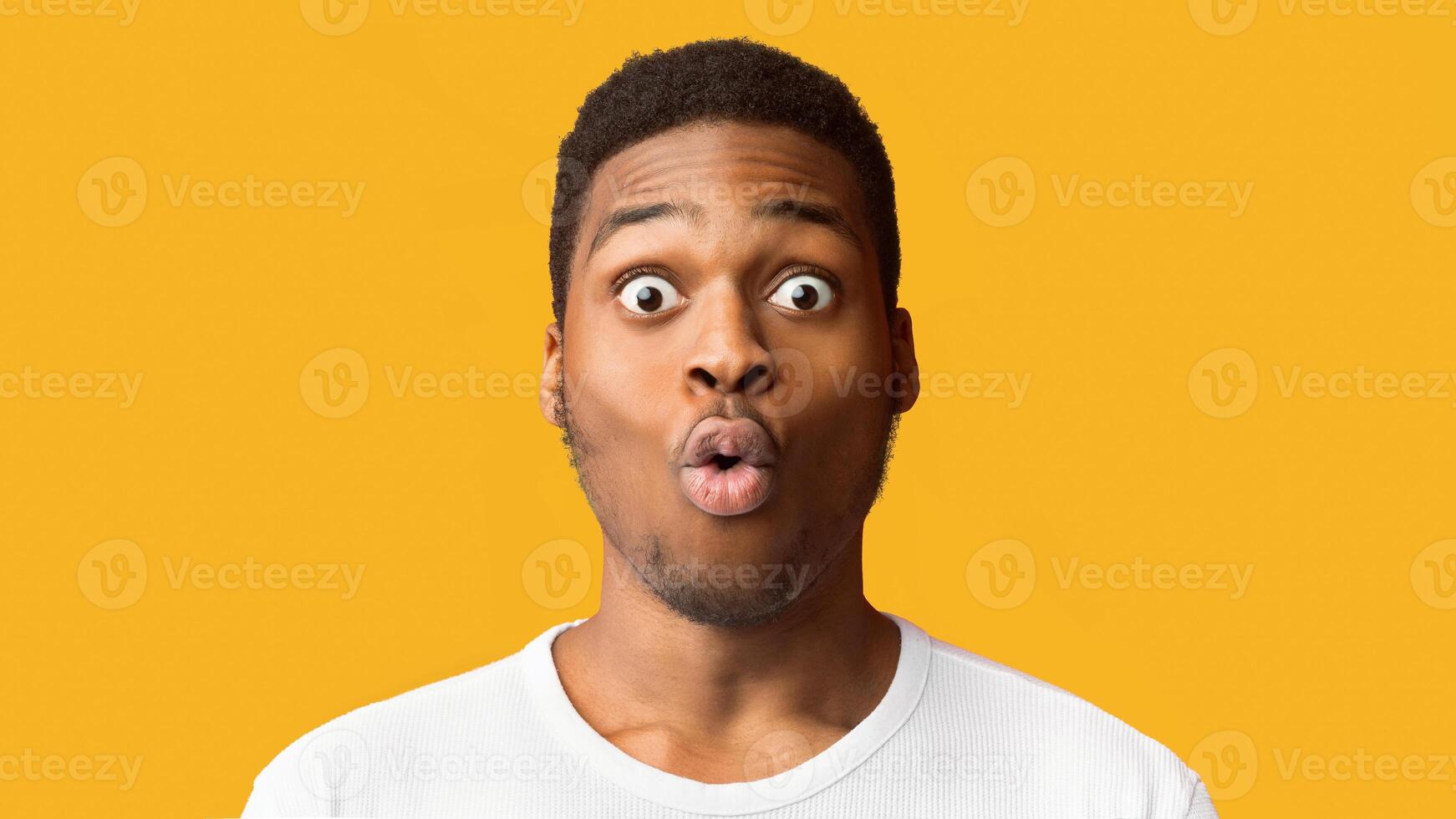 Surprised African American Man Opened Mouth In Amazement, Looking Shocked And Stunned, Free Space photo