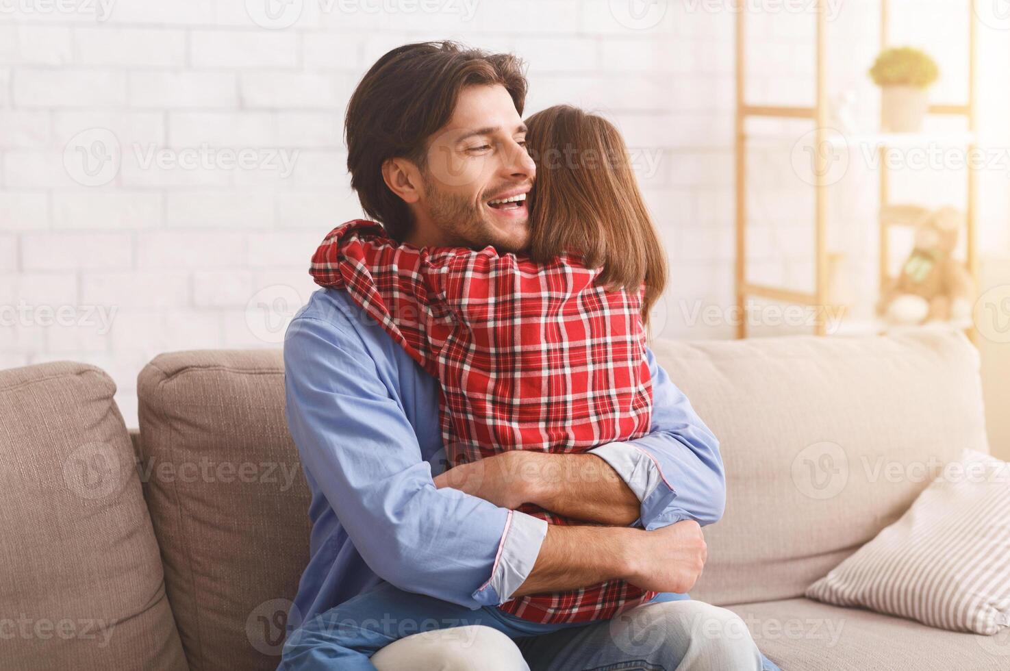 Emotional dad hugging his little daughter, thankful for greeting with Father Day, home interior, copy space photo