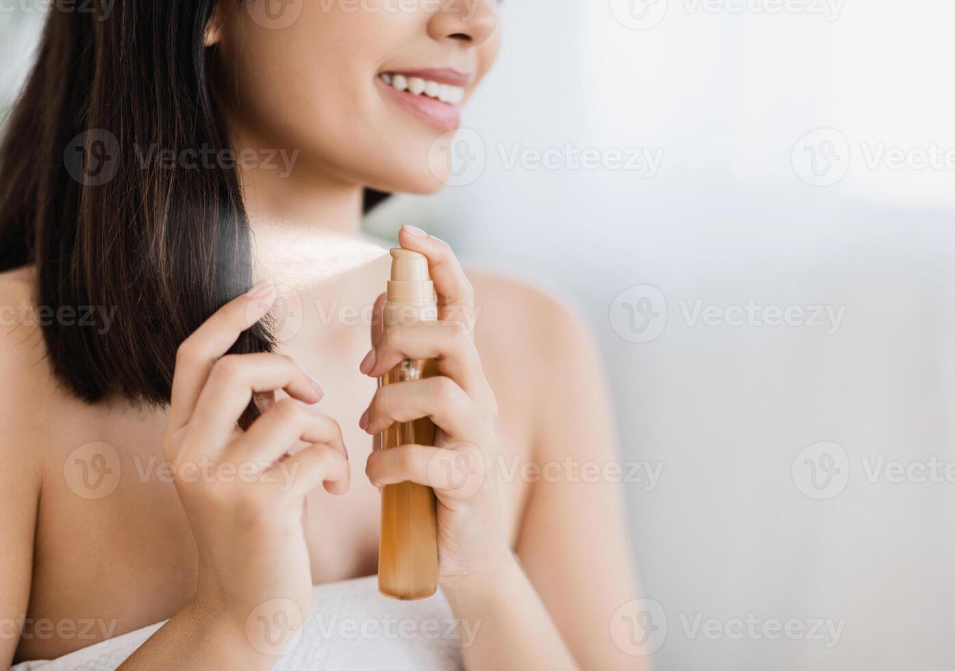 Hair products. Closeup of unrecognizable asian girl using hair spray, copy space photo