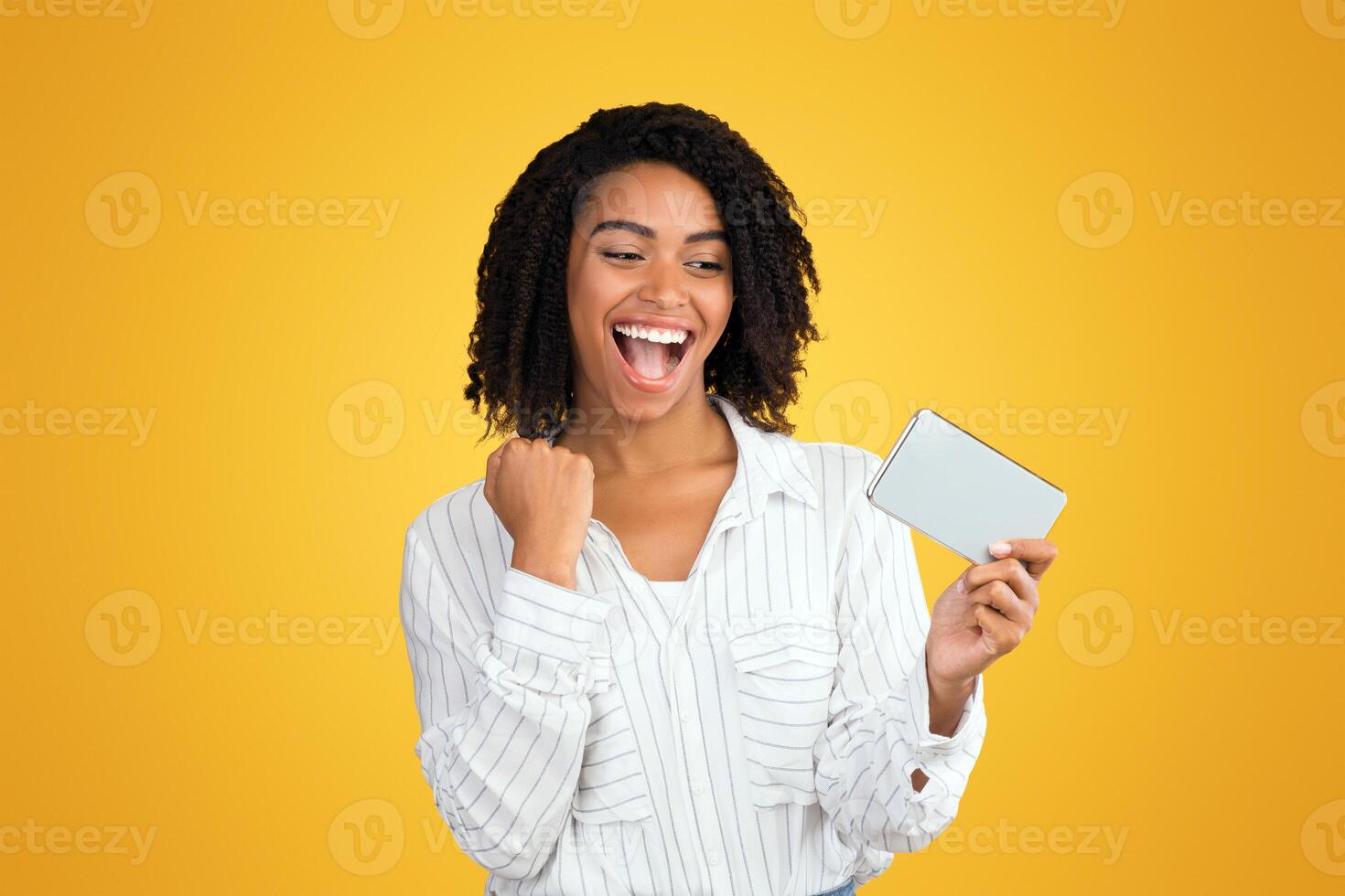 Easy Win, Jackpot. Happy black girl watching match on smartphone, celebrating goal, playing mobile games photo