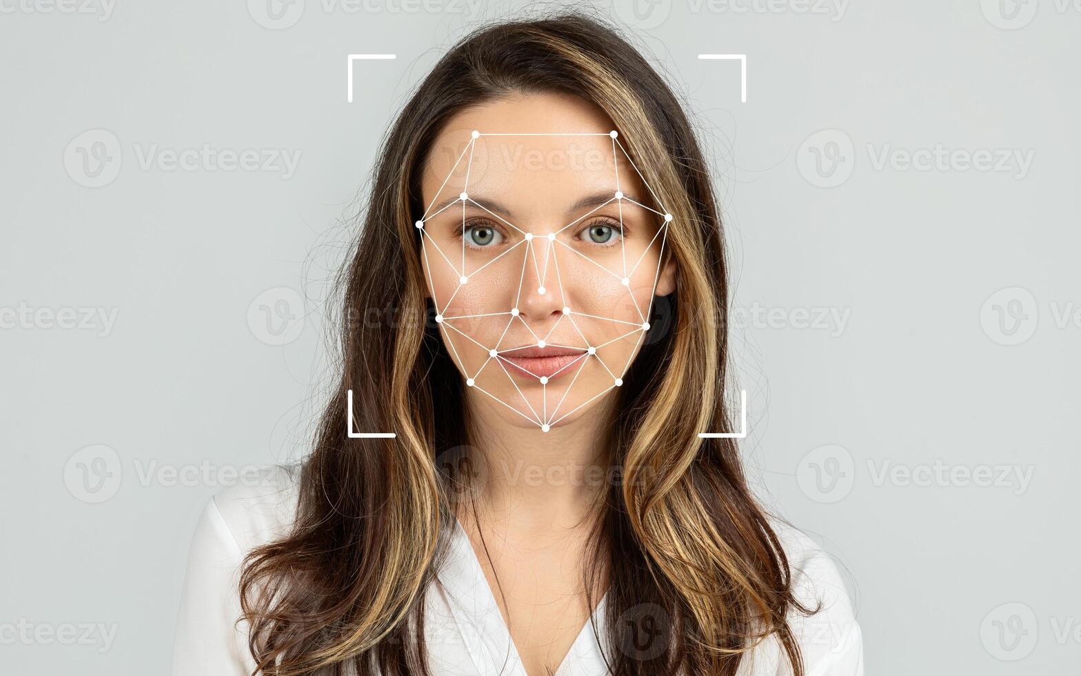 A woman with long hair stands facing the camera, with facial recognition patterns displayed on her face. photo