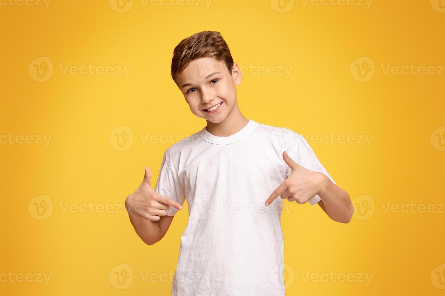 Pick me. Self-assured and charismatic little boy promoting himself, orange studio background photo