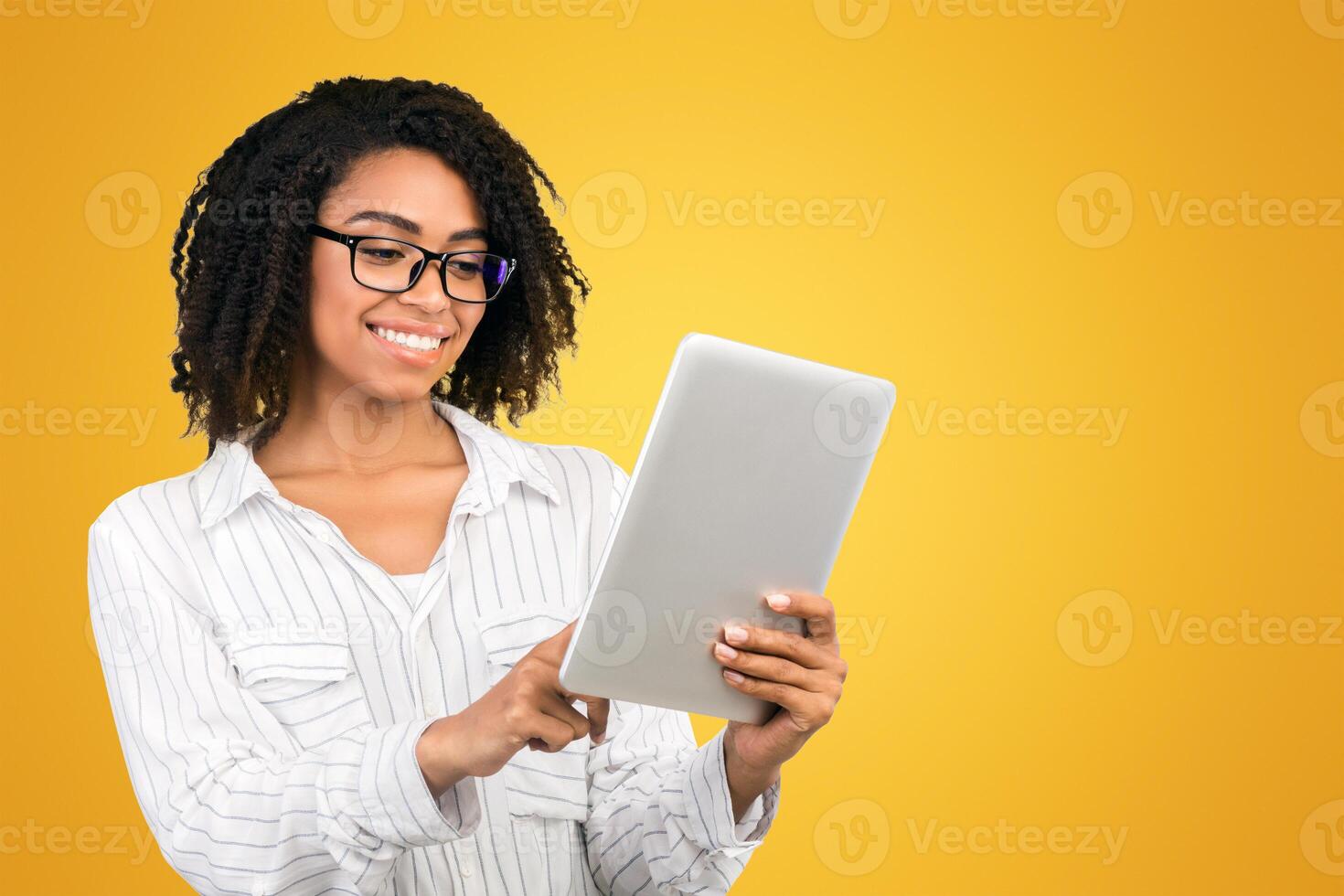 Checking Schedule. Smiling black woman checking appointment on personal tablet over white background, copy space photo
