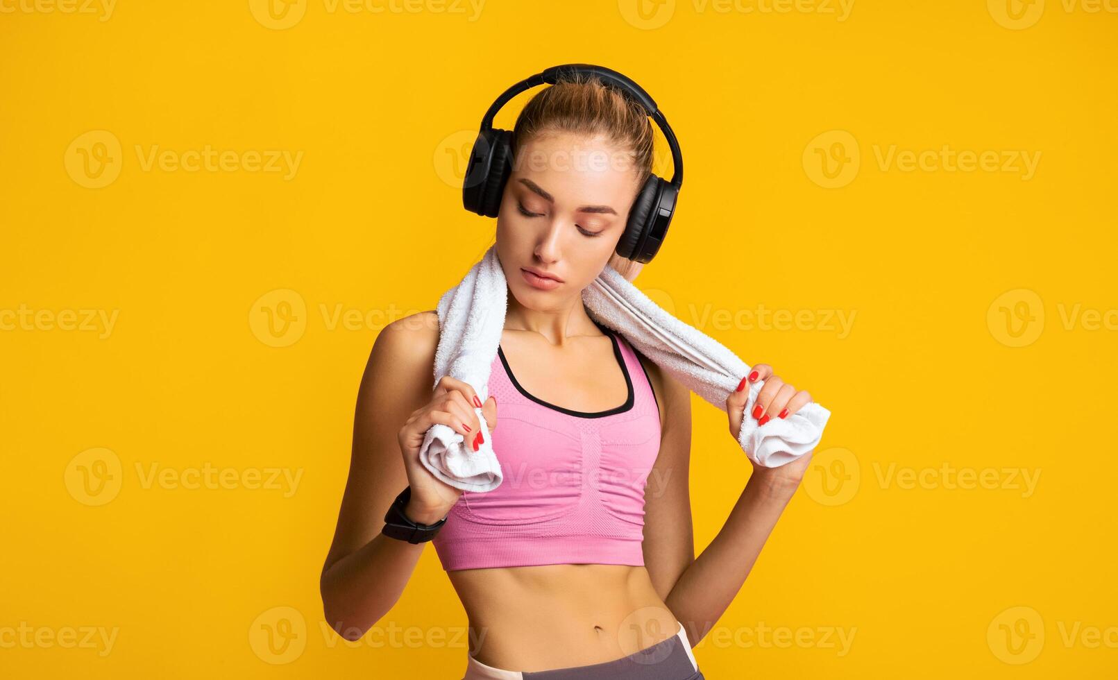 Fit Millennial Girl In Wireless Earphones Listening To Music After Workout Over Pink Background. Studio Shot, Empty Space photo