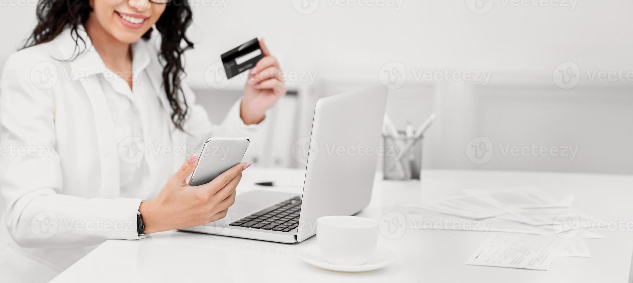Online Shopping. Satisfied woman using smartphone and credit card to buy stuff on the Internet photo