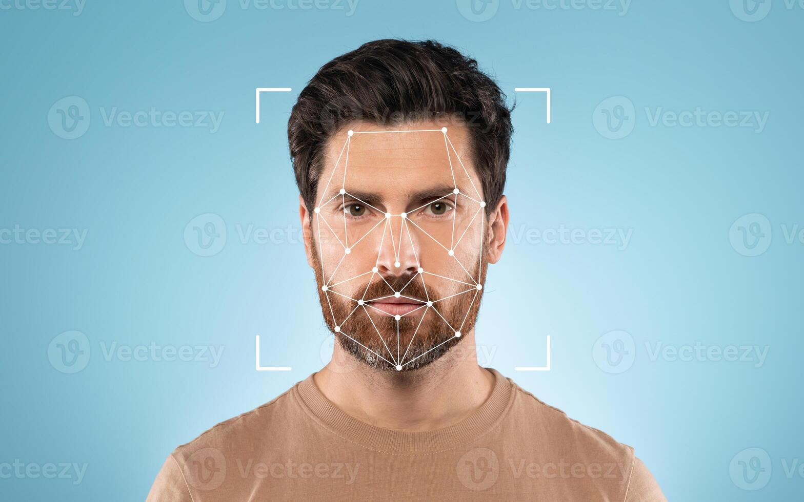 A man stands with a neutral expression while a facial recognition grid overlays his face, set against a solid blue background. photo