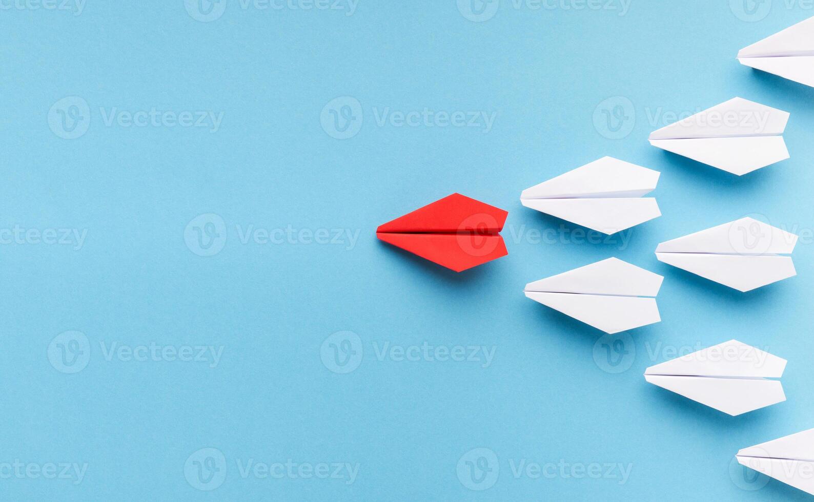 nuevo tendencias concepto. uno rojo papel avión seguido por grupo de blanco unos en azul fondo, Copiar espacio foto