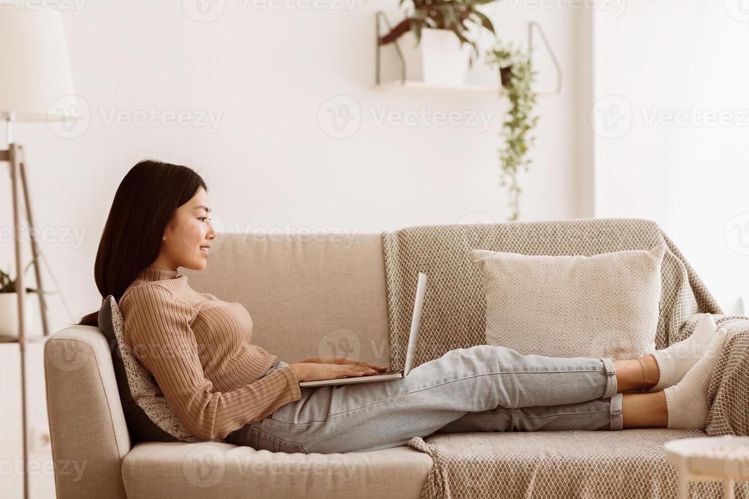 Young Girl Working on Laptop at Home, Typing Plan of New Startup Project, Copy Space, Side View photo