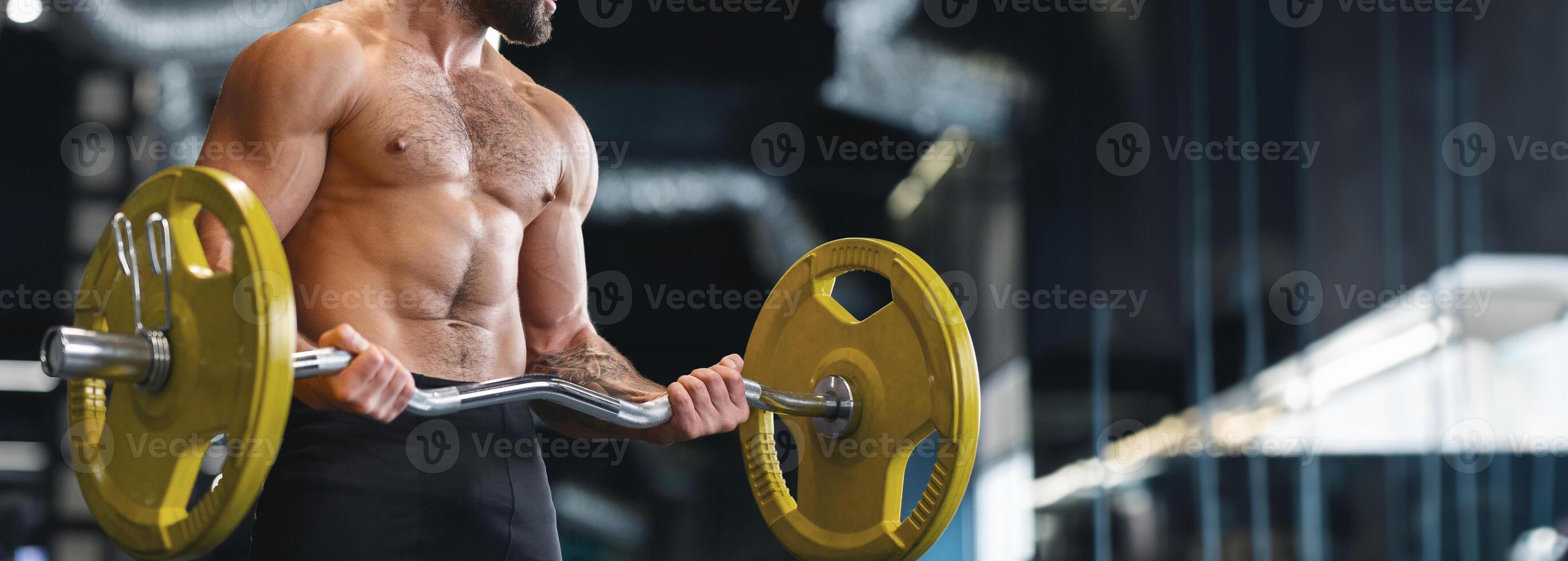 Weightlifting. Muscular bodybuilder exercising with heavy barbell in gym, panorama with copy space, cropped photo