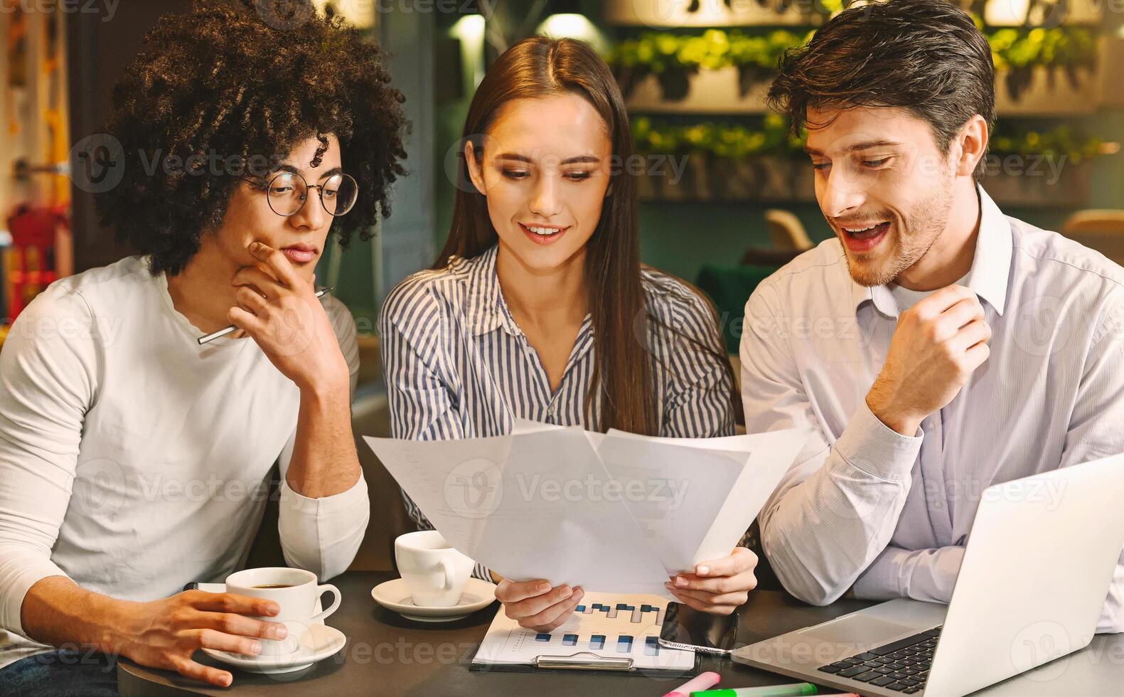 Millennial business team discussing project in cafe, reading contract terms and conditions during business lunch, free space photo