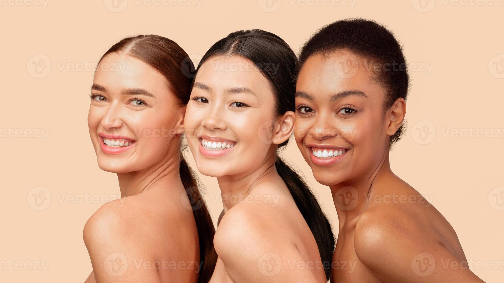 Beauty And Skincare. Portrait Of Three Multiethnic Girls Smiling At Camera Posing Over White Studio Background. Panorama photo