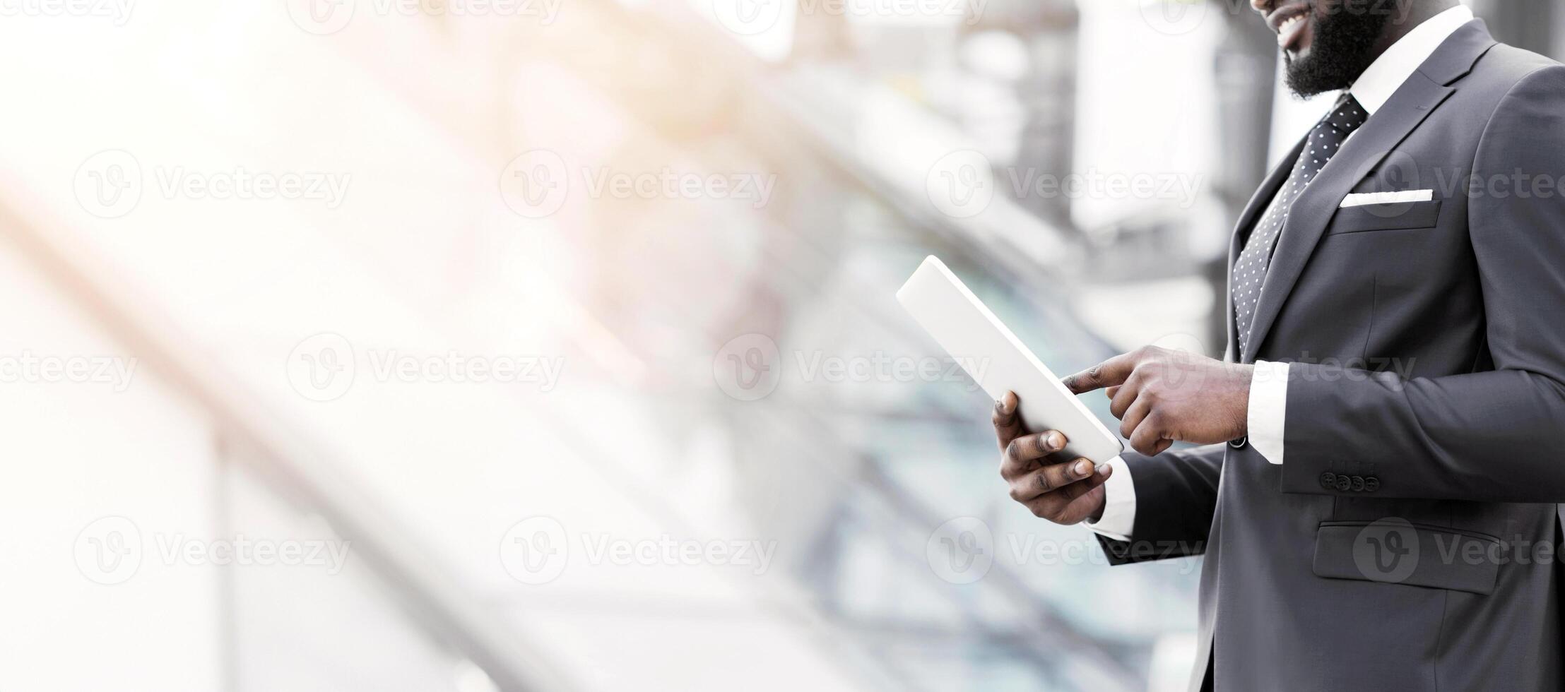 Black Business Guy Browsing On Digital Tablet Walking In Urban Area. Cropped, Empty Space photo