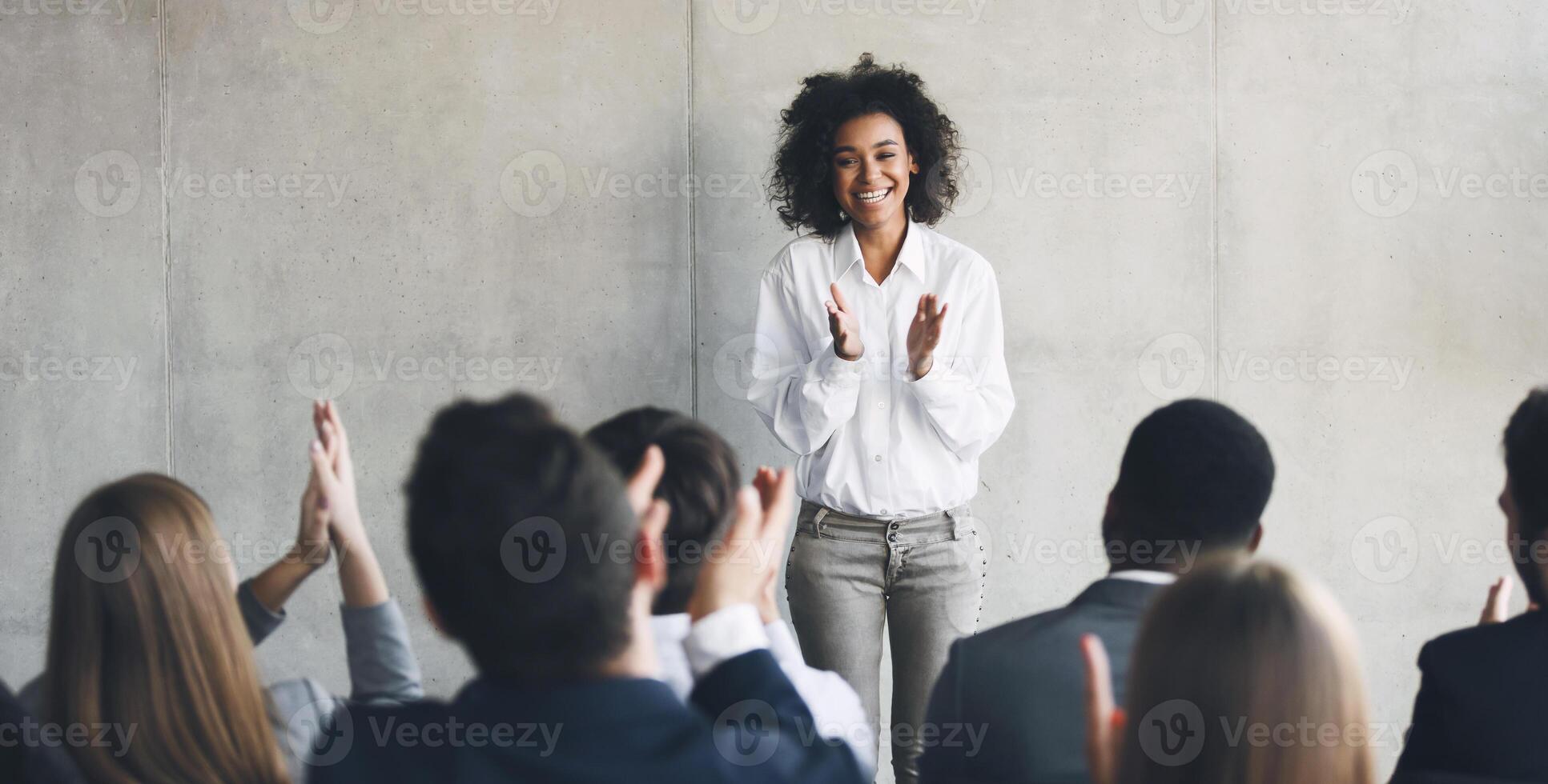 Business presentation. Grateful audience clapping hands to speaker after informative training photo