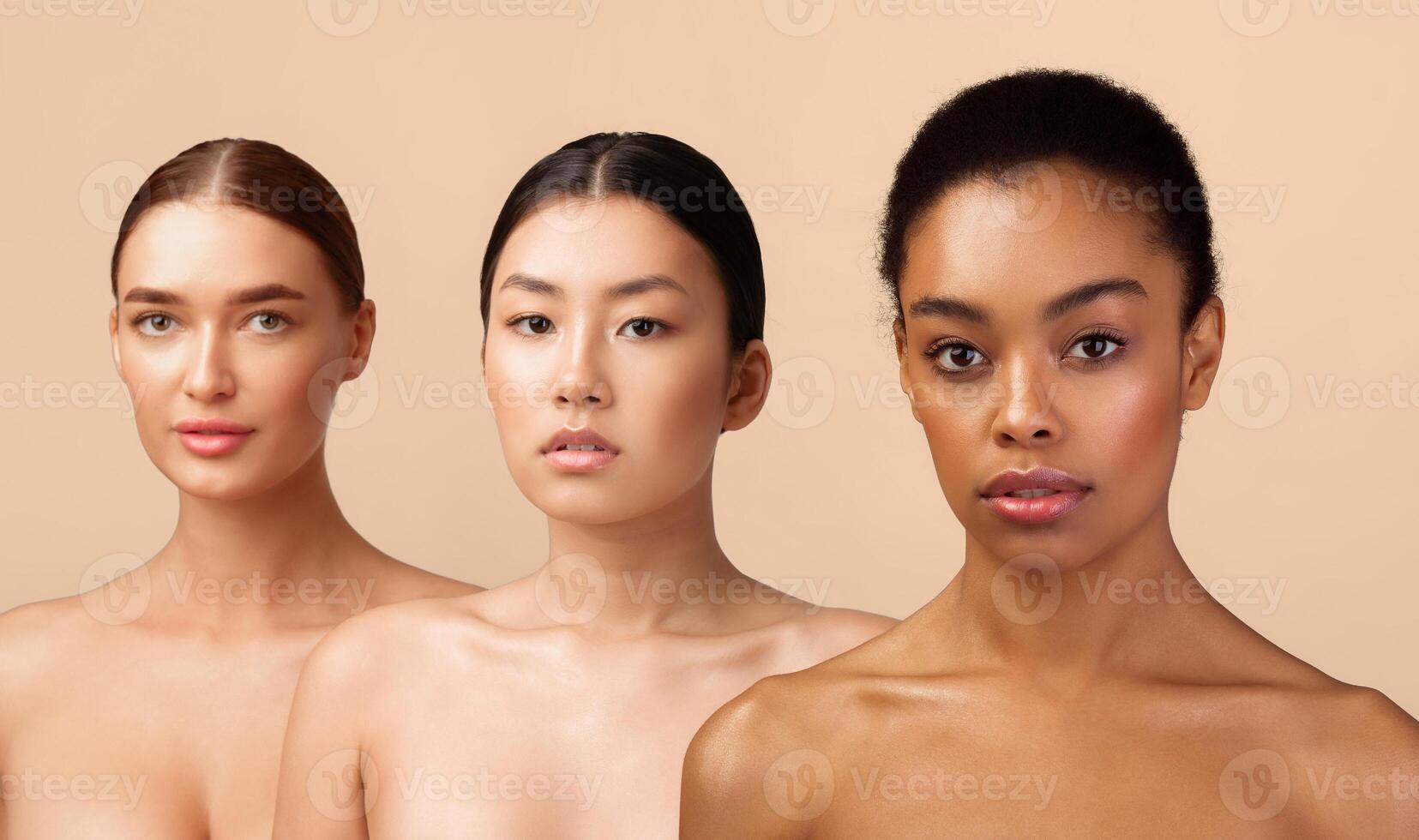 Beauty Portrait. Three Multiracial Women With Perfect Faces And Skin Posing Naked Looking At Camera On Gray Background In Studio. photo