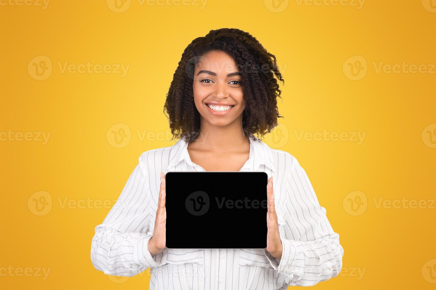 Tablet App Advertising. Black woman showing blank computer screen at studio over white background. Empty space, mockup photo