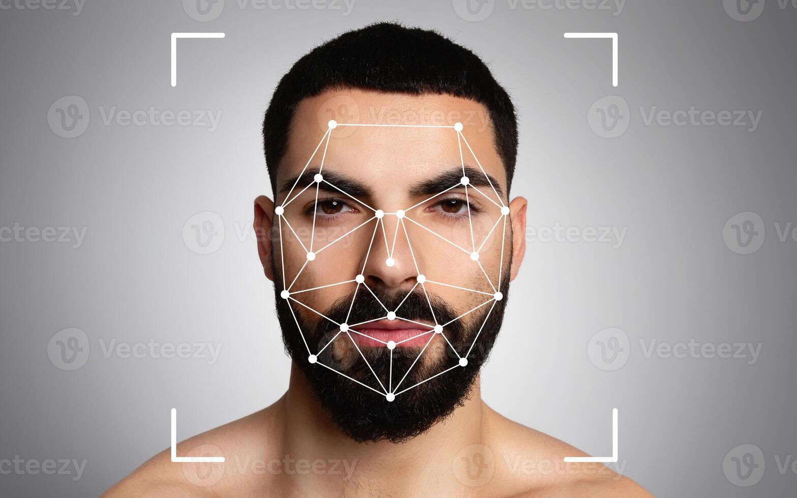 Middle eastern man is undergoing facial recognition analysis, with pattern mapping visible on his face against a neutral background. photo