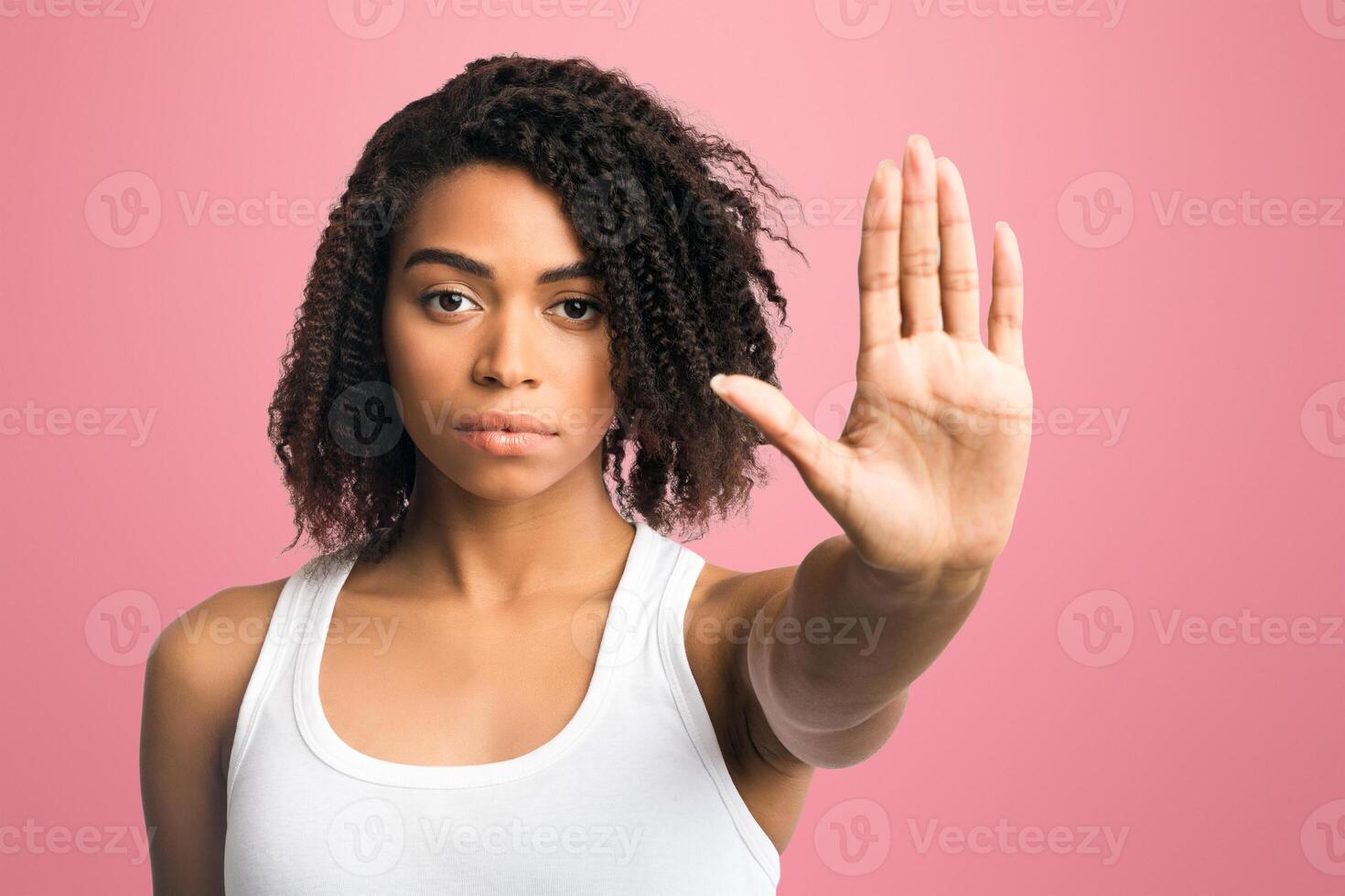 Enough, Time To Stop. Serious african american woman showing palm or no gesture, being disappointed photo