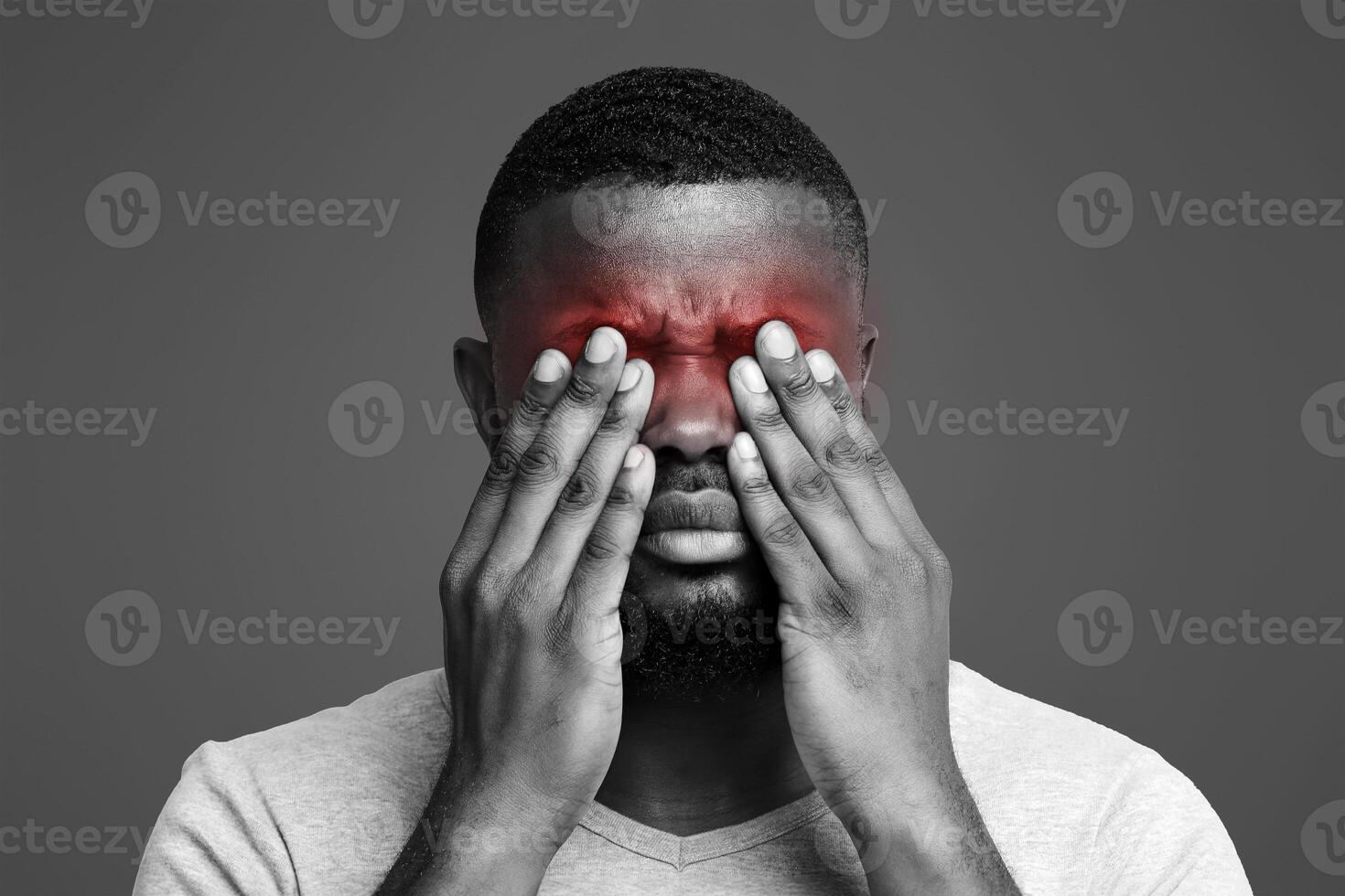 Overworked afro man rubbing eyes, suffering from eye pain photo