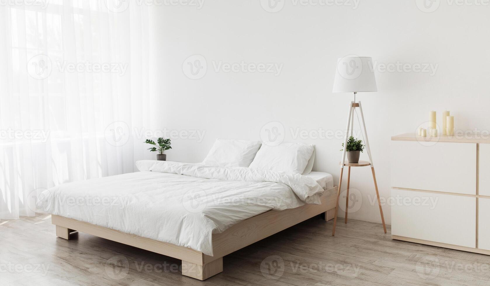 Simple modern design, ad, offer. Double bed with white pillows and soft blanket, lamp, furniture on wooden floor. White empty wall, big window with curtains in bedroom interior photo