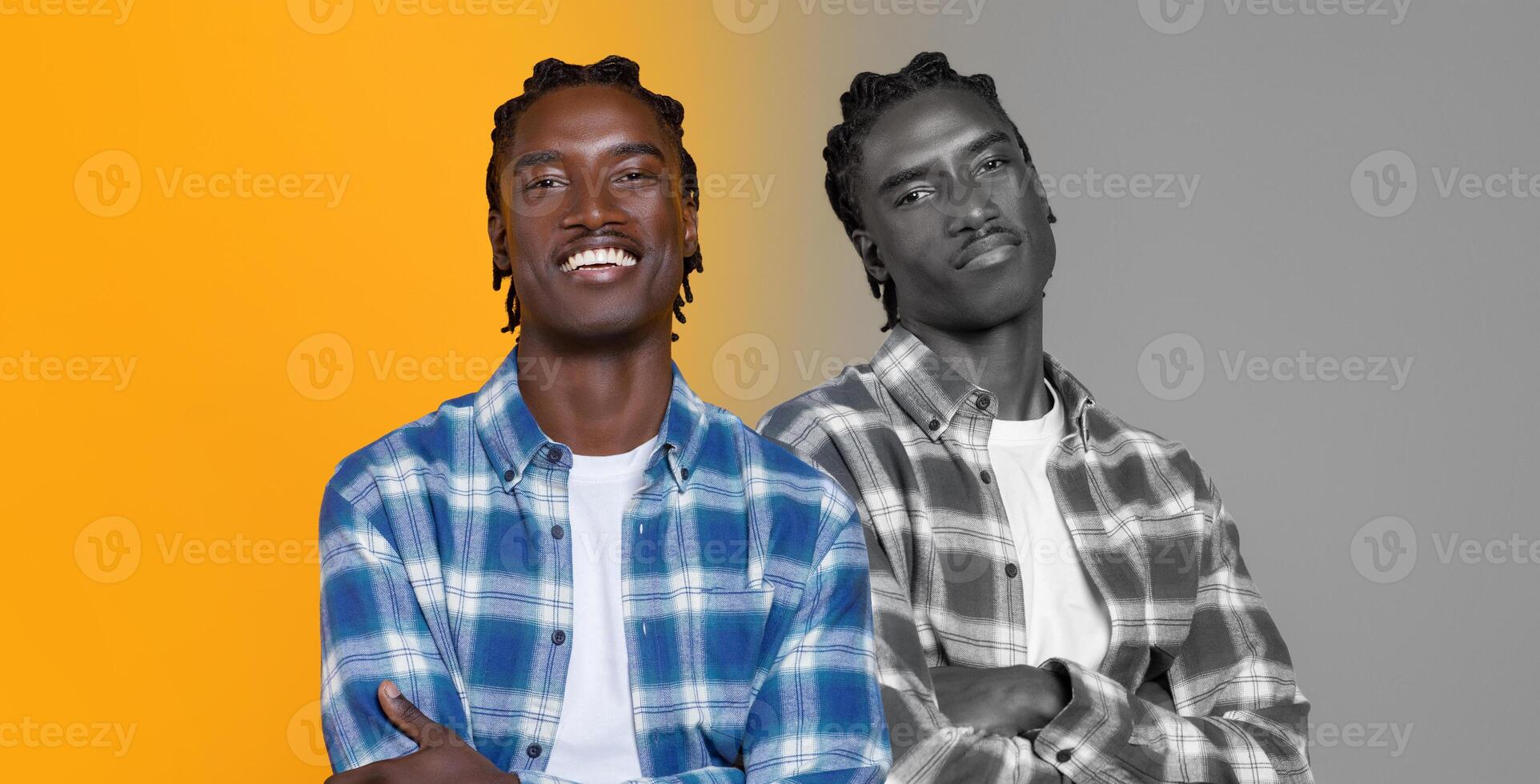 A young black man stands confidently, smiling broadly while wearing a plaid shirt over a t-shirt. He is positioned between two contrasting backgrounds, one vibrant yellow and the other in monochrome photo