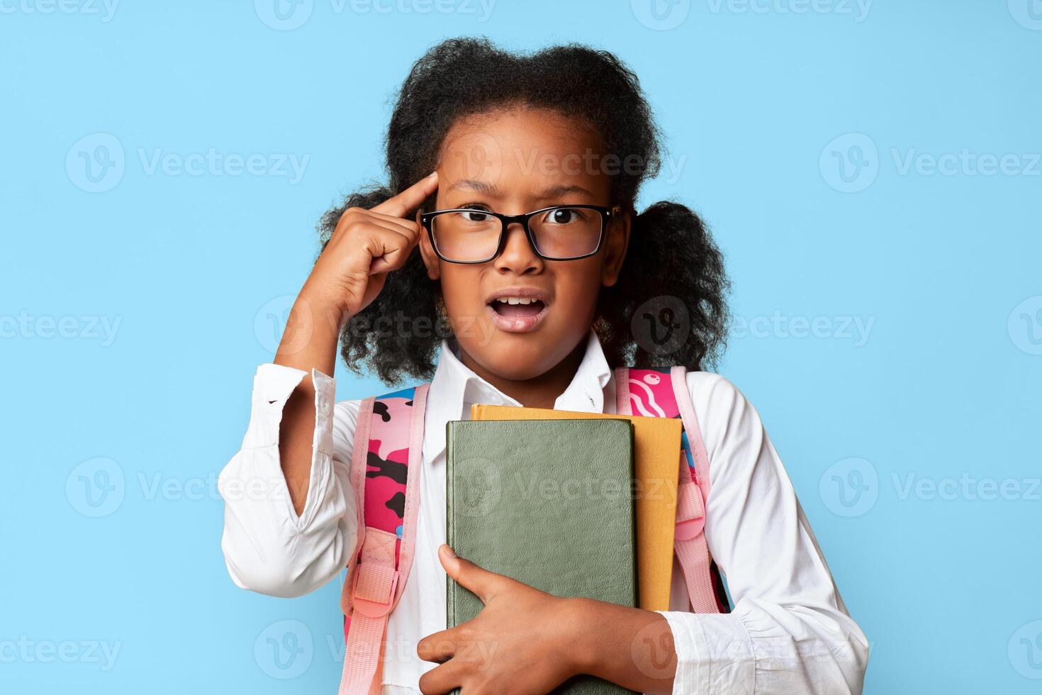 Quarantine Homework. Confused Schoolgirl Holding Books Looking At Camera Posing On Yellow Background. Studio Shot photo